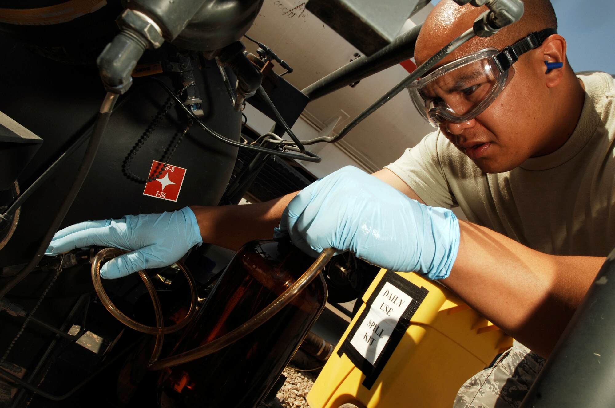 JOINT BASE BALAD, Iraq -- Staff Sgt. Benjamin Laguana collects a fuel sample from a tanker here Aug. 12. The fuel is checked regularly to ensure no contaminants are present. Sergeant Laguana, a fuels laboratory technician with the 332nd Expeditionary Logistics Readiness Squadron here, is deployed from Holloman Air Force Base, N.M. His hometown is Long Beach, Calif. (U.S. Air Force photo/Airman 1st Class Jason Epley)