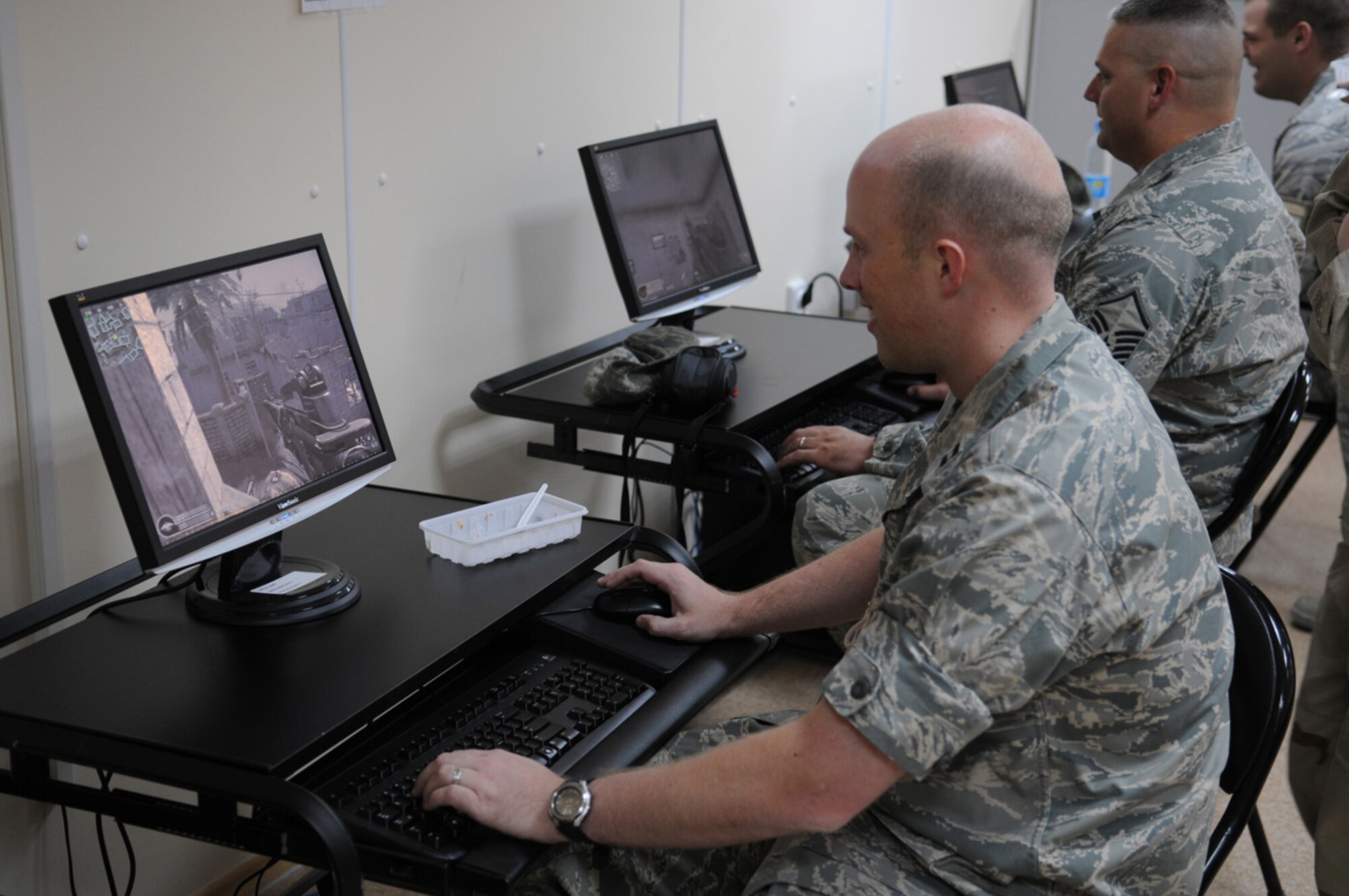 08/11/2008 - MANAS AIR BASE, KYRGYZ REPUBLIC -- Airmen enjoy the new gaming computers at the Liberandos Lair morale and recreation center shortly after its official ribbon cutton ceremony here, Aug. 11. The 3,800 sq. foot center houses morale computers and phones, two movie theaters and a game room. It was built to ease congestion in Manas AB's existing morale centers and make coalition servicemembers' stay at Manas more enjoyable while they are transiting in and out of Afghanistan. (Air Force photo / Airman 1st Class Ruth Holcomb)