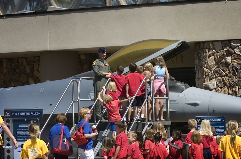Capt. Dan McGuire (in flightsuit) answers questions about the F-16 Fighting Falcon during Air Force Week in the Heartland Aug. 12 at the Henry Doorly Zoo in Omaha, Neb. Captain McGuire is a pilot with the 56th Training Squadron from Luke Air Force Base, Ariz. Zoo visitors also had the chance to see the Do Something Amazing display, a motion simulator and video simulators during Air Force Week in the Heartland. (U.S. Air Force photo/Lance Cheung)