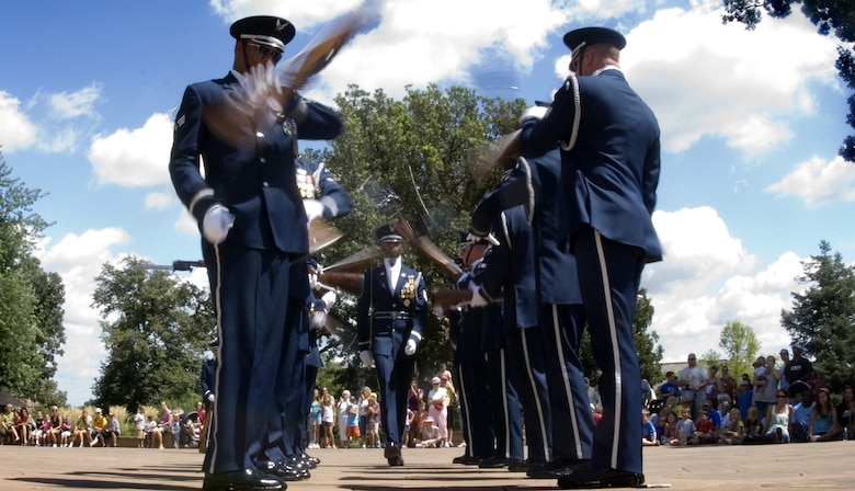 Tech. Sgt. Robert Jones walks the gauntlet of flying M1 rifles as Air Force Honor Guard drill team members perform Aug. 12 for visitors of the Henry Doorly Zoo in Omaha, Neb. Zoo visitors also had the chance to see the Do Something Amazing display featuring an F-16 Fighting Falcon, a motion simulator and video simulators during Air Force Week in the Heartland. (U.S. Air Force photo/Lance Cheung)