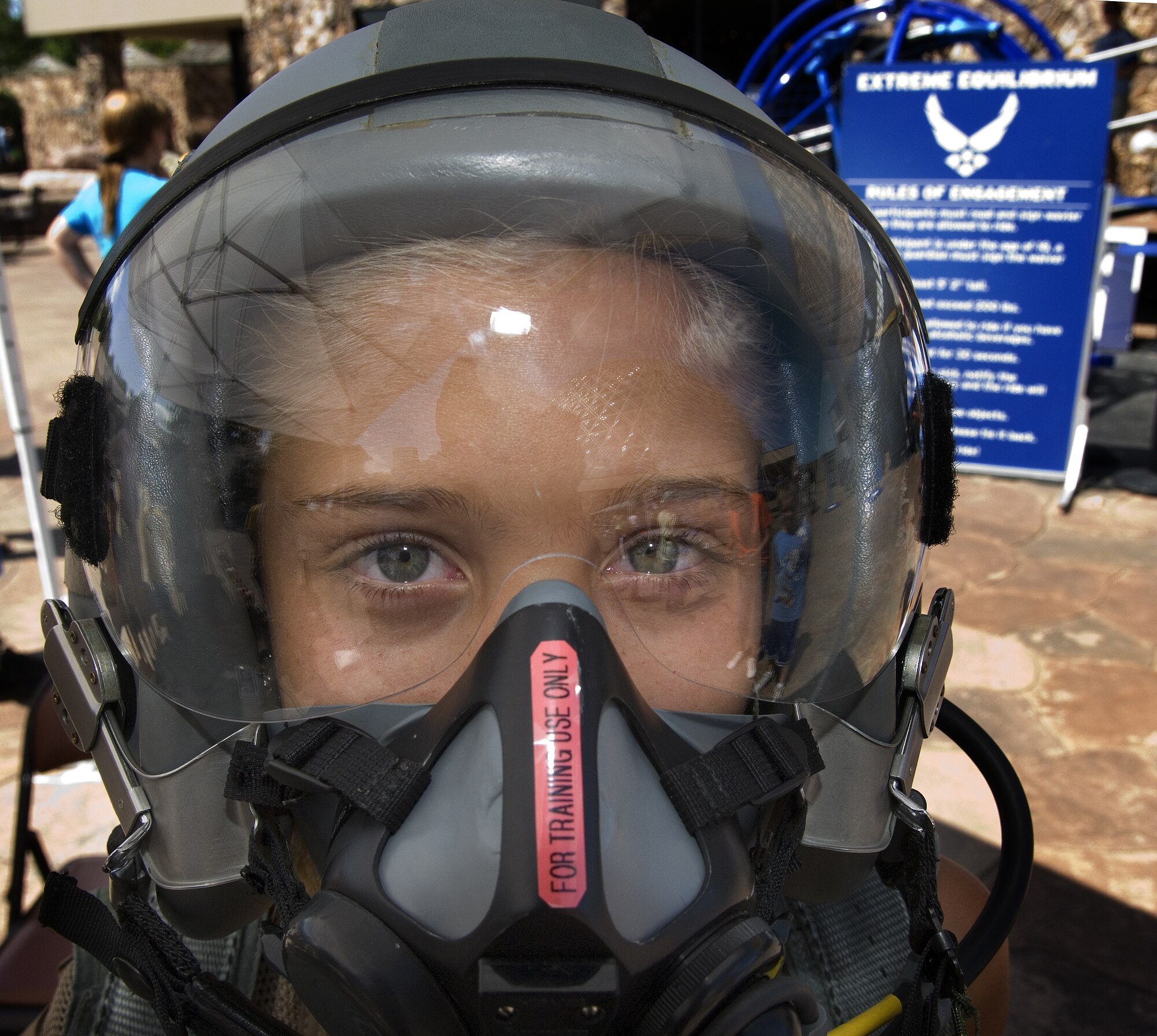 Kathryn Jacobs tries on fighter pilot gear during Air Force Week in the Heartland Aug. 12 at the Henry Doorly Zoo in Omaha, Neb. Zoo visitors also had the chance to see the Do Something Amazing display, a motion simulator and video simulators during Air Force Week in the Heartland. (U.S. Air Force photo/Lance Cheung)