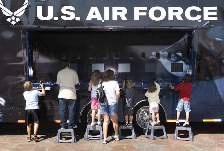 Visitors use the Do Something Amazing video simulators during Air Force Week in the Heartland Aug. 12 at the Henry Doorly Zoo in Omaha, Neb. Zoo visitors had a chance to see an F-16 Fighter Falcon, a motion simulator, video simulators and Air Force Honor Guard drill team performances. (U.S. Air Force photo/Lance Cheung)