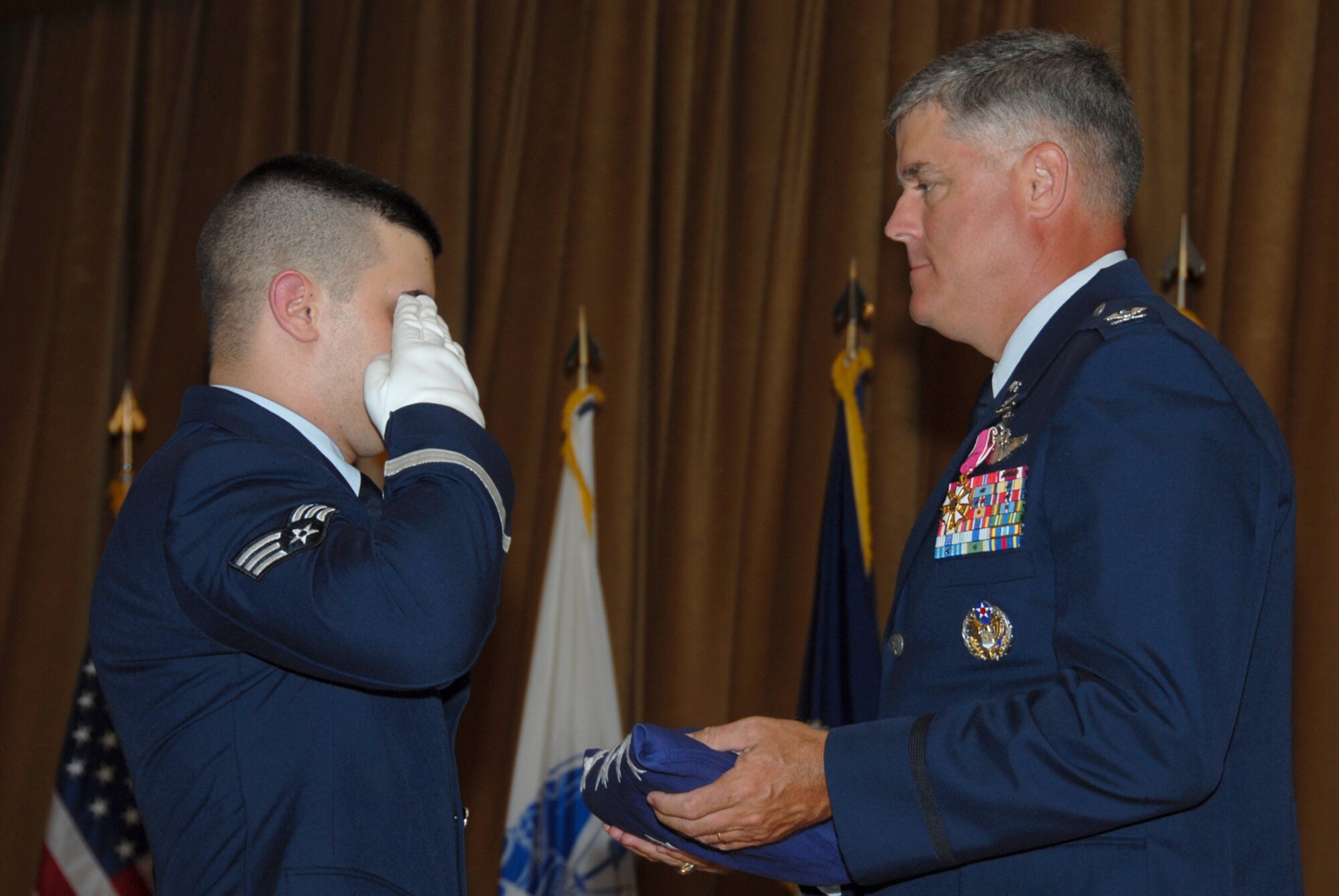 MISAWA AIR BASE, Japan -- During his retirement ceremony here August 4, 2008, Col. Joel Malone, 35th Fighter Wing vice commander, receives a flag flown over the U.S. Capitol in Washington D.C. in honor of his 26 years of military service. (U.S. Air Force photo by Senior Airman Laura R. McFarlane)