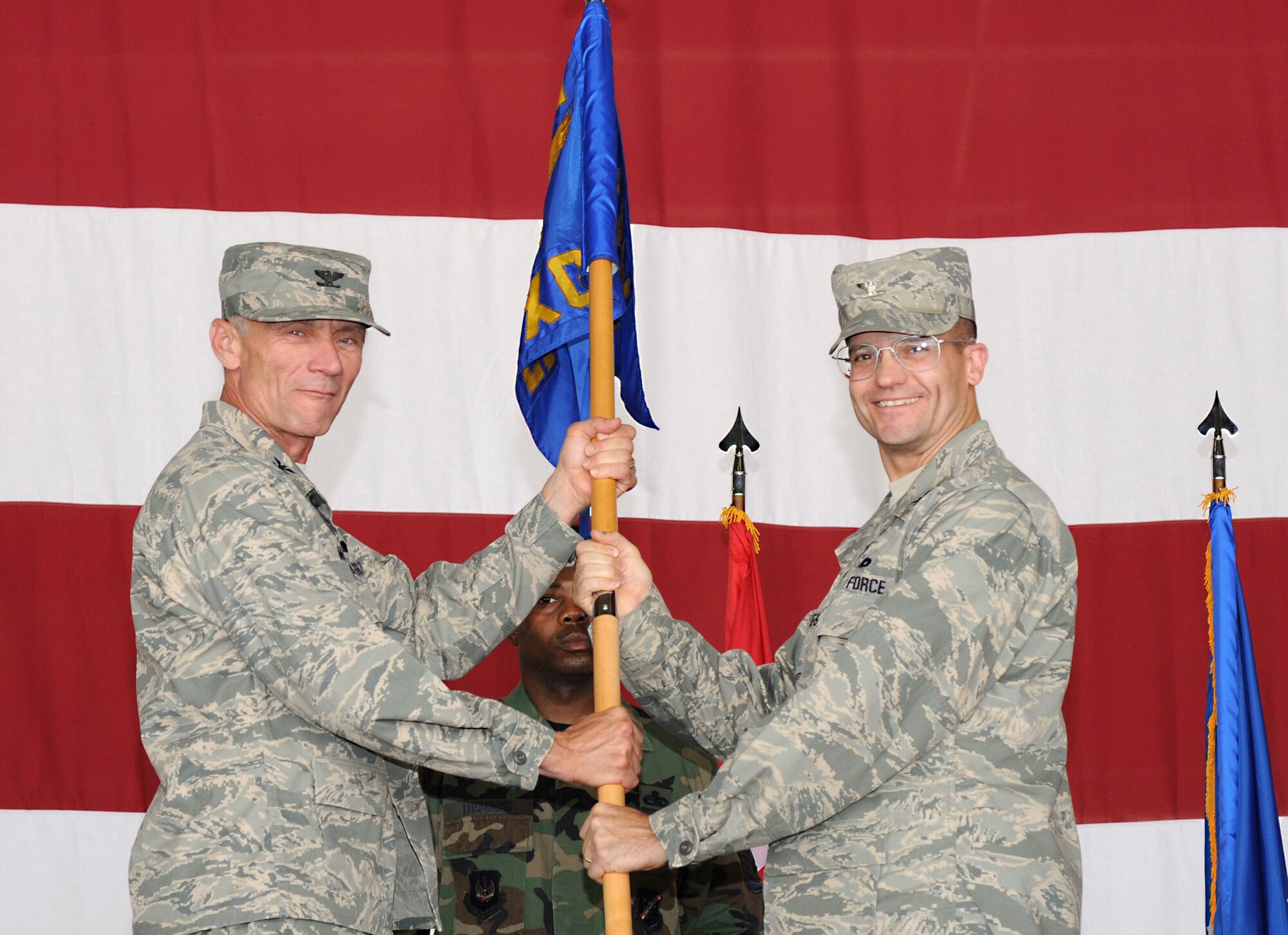 Col. Eric Gates (right) takes command of the 39th Maintenance Group after receiving the 39 MXG guidon from Col. Phil McDaniel, 39th Air Base Wing commander, during a change-of-command ceremony Aug. 11 in Hangar 4. (U.S. Air Force photo by Airman 1st Class Amber Russell)