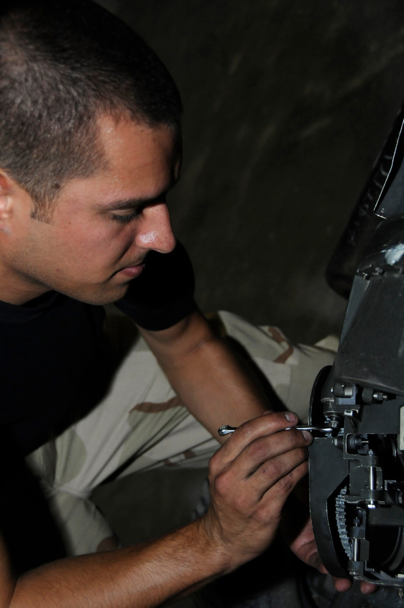Staff Sergeant Christopher Ospina, armament team chief with the 379th Expeditionary Maintenance Squadron, connects an exit unit to the universal ammunition loading system Aug. 12, 2008, at an undisclosed air base in Southwest Asia. The 379th Expeditionary Maintenance Squadron is responsible for maintaining aircraft to ensure they can complete their mission throughout the US Central Command’s area of responsibility. Sergeant Ospina, a native of Savannah, Ga., is deployed from Ellsworth Air Force Base, S.D., in support of Operations Iraqi Freedom, Enduring Freedom and Joint Task Force-Horn of Africa. (U.S. Air Force photo by Staff Sgt. Darnell T. Cannady/Released)