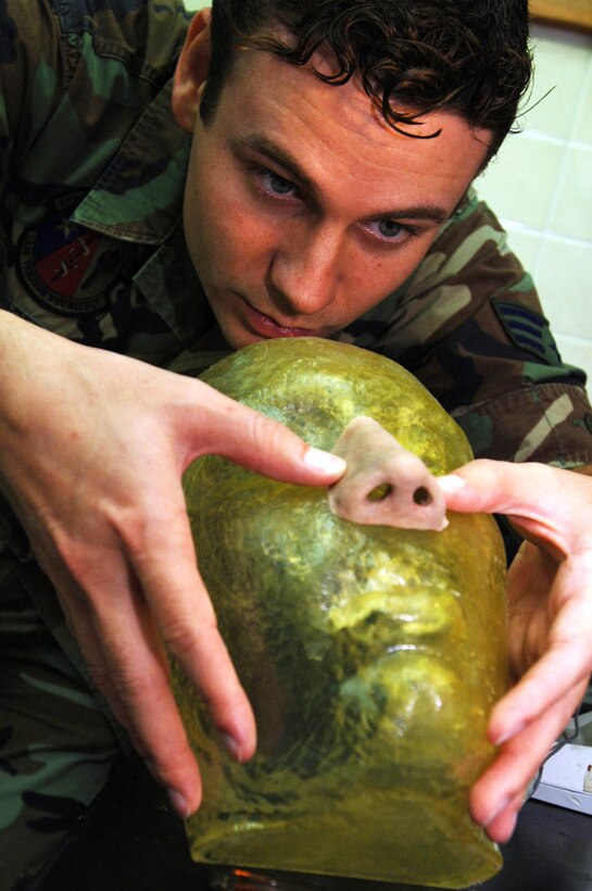 Maxillofacial prosthetic technician Air Force Senior Airman Justin Jones checks the fit and finish on a nose he is sculpting as part of a patient's reconstructive treatment. Jones is assigned to 59th Dental Squadron at Lackland Air Force Base, Texas. U.S. Air Force photo by Staff Sgt. Erin Peterson, 59th Medical Wing
