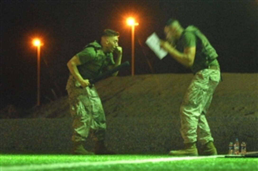 U.S. Marine Corps Cpl. David J. Chavez, a Marine Corps Martial Arts Program instructor, and Lance Cpl. Daniel Grandbois participate in training on Camp Lemonier, Djibouti, Aug. 8, 2008. 