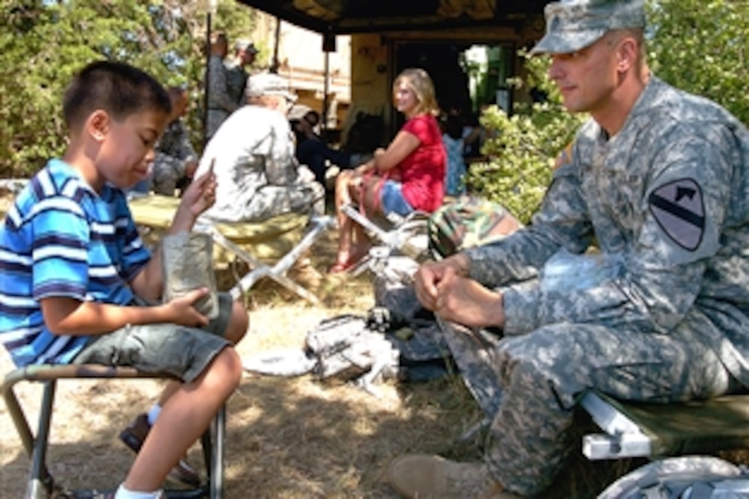 U.S. Army 1st Sgt. Christopher Towns and his 9-year-old son Anthony share an MRE for lunch during the 1st Cavalry Division’s family day on Fort Hood, Texas, Aug. 7, 2008. Towns is assigned to the 1st Cavalry Division's 3rd Battalion, 82nd Field Artillery Regiment.