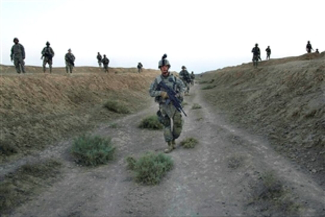 U.S. and Iraqi  soldiers search a canal for extremist activity near Tamuz, Iraq, Aug. 8, 2008. The U.S. Army soldiers are ssigned to the 1st Armored Division's Company A, 1st Battalion, 35th Regiment. 
