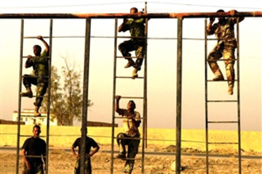 Iraqi army soldiers run an obstacle course as a start to their physical fitness training on Camp Echo, Iraq, Aug.12, 2008.