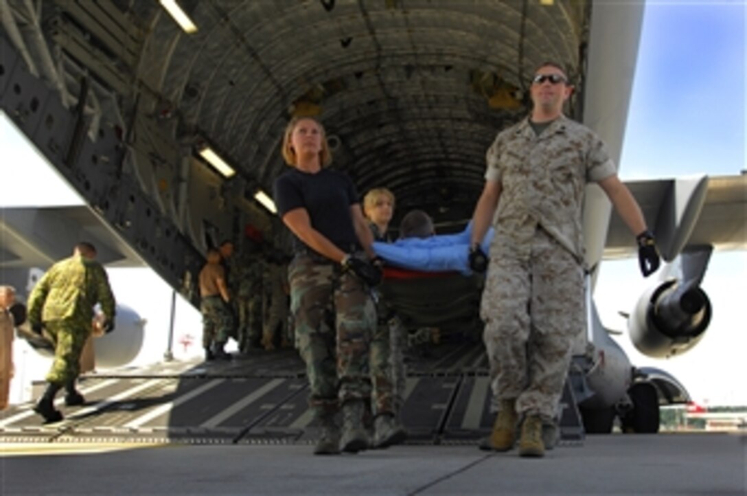 Wounded military members are carried from an aeromedical evacuation flight at Ramstein Air Base, Germany, on July 31, 2008.  The patients are then taken to Landstual Regional Medical Center for further treatment.  