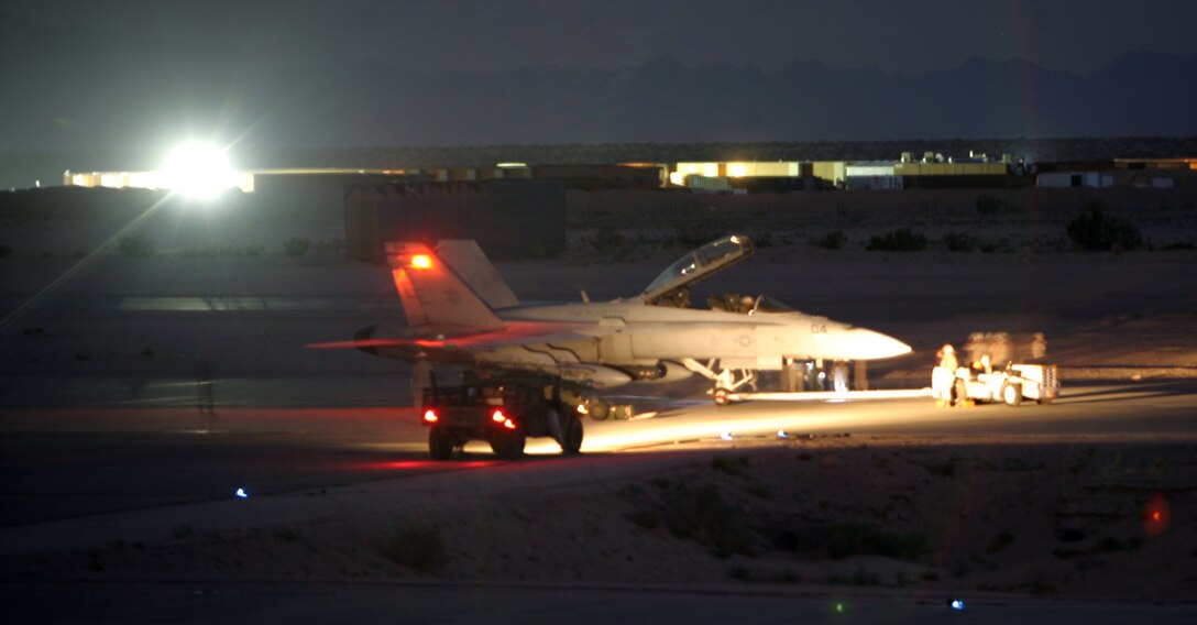 Marines from Marine Wing Support Squadron 374 and a recovery crew with Marine Fighter Attack Squadron 225, Marine Aircraft Group 11, 3rd Marine Aircraft Wing, based at Marine Corps Air Station Miramar, Calif., remove an F/A-18D Hornet from VMFA-225 that had to make an emergency landing at the Expeditionary Airfield aboard the Combat Center Aug. 13.