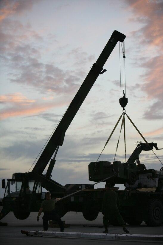 Marines from a recovery crew with Marine Fighter Attack Squadron 225, Marine Aircraft Group 11, 3rd Marine Aircraft Wing, based at Marine Corps Air Station Miramar, Calif., unload equipment, Aug. 14, to remove an F/A-18D Hornet from VMFA-225 that had to make an emergency landing at the Expeditionary Airfield aboard the Combat Center Aug. 13.