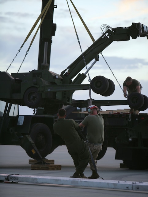Marines from a recovery crew with Marine Fighter Attack Squadron 225, Marine Aircraft Group 11, 3rd Marine Aircraft Wing, based at Marine Corps Air Station Miramar, Calif., unload equipment, Aug. 14, to remove an F/A-18 Hornet from VMFA-225 that had to make an emergency landing at the Expeditionary Airfield aboard the Combat Center Aug. 13.