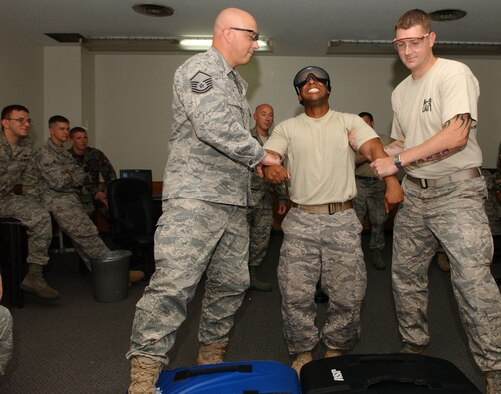 YOKOTA AIR BASE, Japan -- Staff Sgt. Jay King, 374th Security Forces Squadron assistant flight chief, is shocked by the X26C taser during training Aug. 14. Several members from the 374th SFS unit participated in taser training and some members volunteered for a live demonstration. (U.S. Air Force photo by Airman 1st Class Eric Summers)