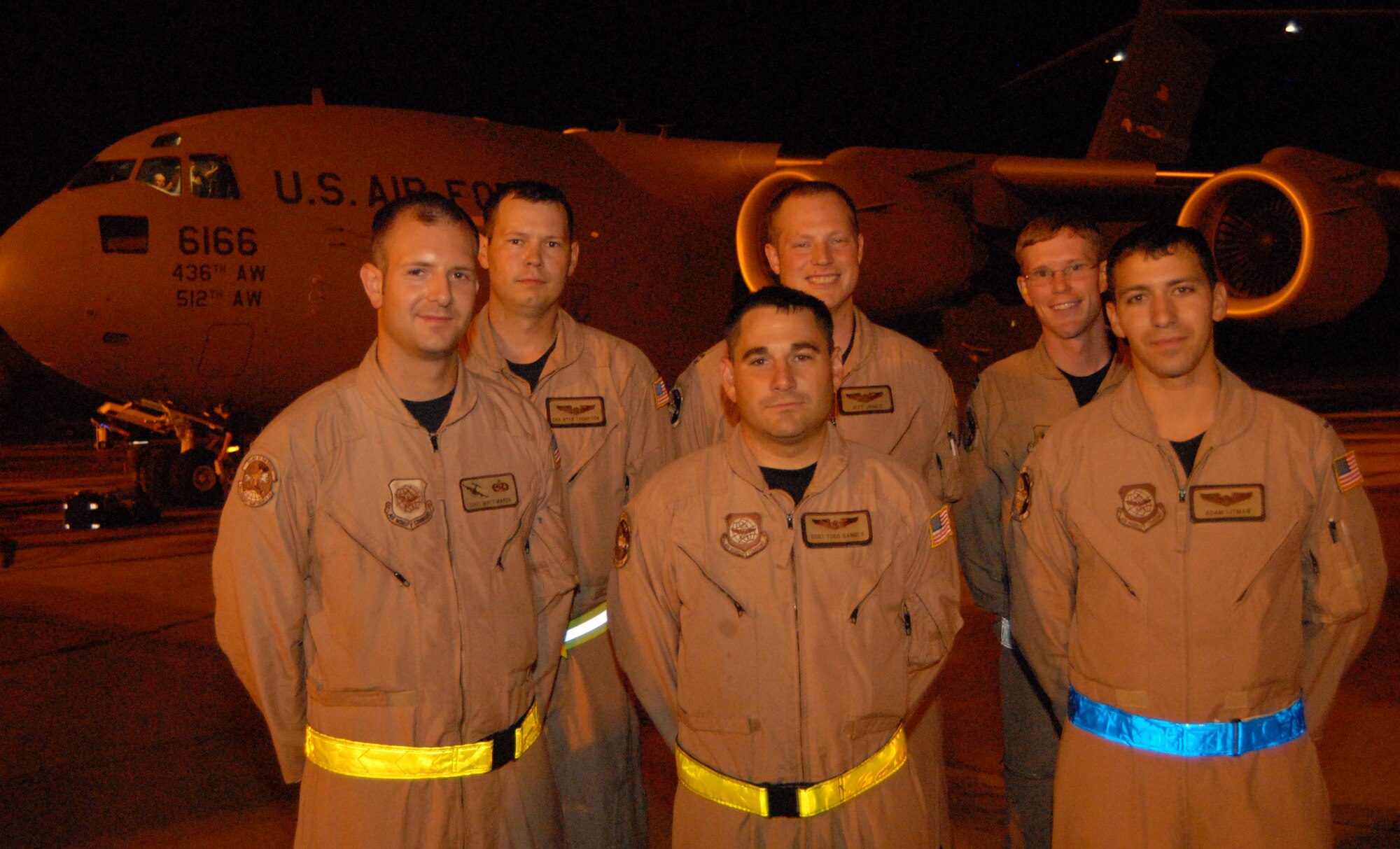 DOVER AIR FORCE BASE, Del. – (Left to right front row) Staff Sgt. Mathew Marsh, 736th Aircraft Maintenance Squadron, Staff Sgt. Todd Barney, 1st Lt. Adam Litman, (left to right back row) Senior Airman Ryan Thompson, Capt. Jeff Jones and Capt. Scott Motley, 3rd Airlift Squadron, were six of the seven Team Dover Airmen who flew the first C-17 Globemaster III providing humanitarian aid to the Republic of Georgia Aug. 13. (U.S. Air Force photo/Senior Airman James Bolinger)