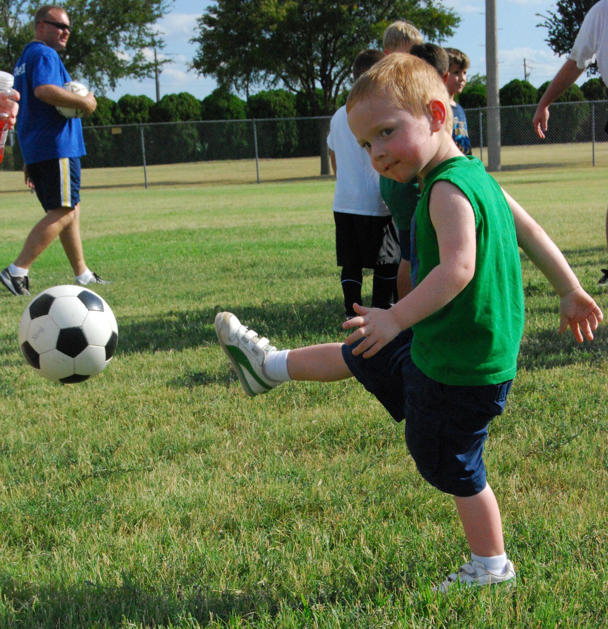 Riley Imber, 3, practices dribbling a soccer ball at the Madrigal Youth Center Soccer Clinic for Kids Aug.14. The clinic was held as a practice session to prepare for the fall soccer season. Members of the Midwestern State University Girls Soccer Team helped the children practice various soccer drills and techniques. (U.S. Air Force photo/Airman 1st Class Candy Miller) 