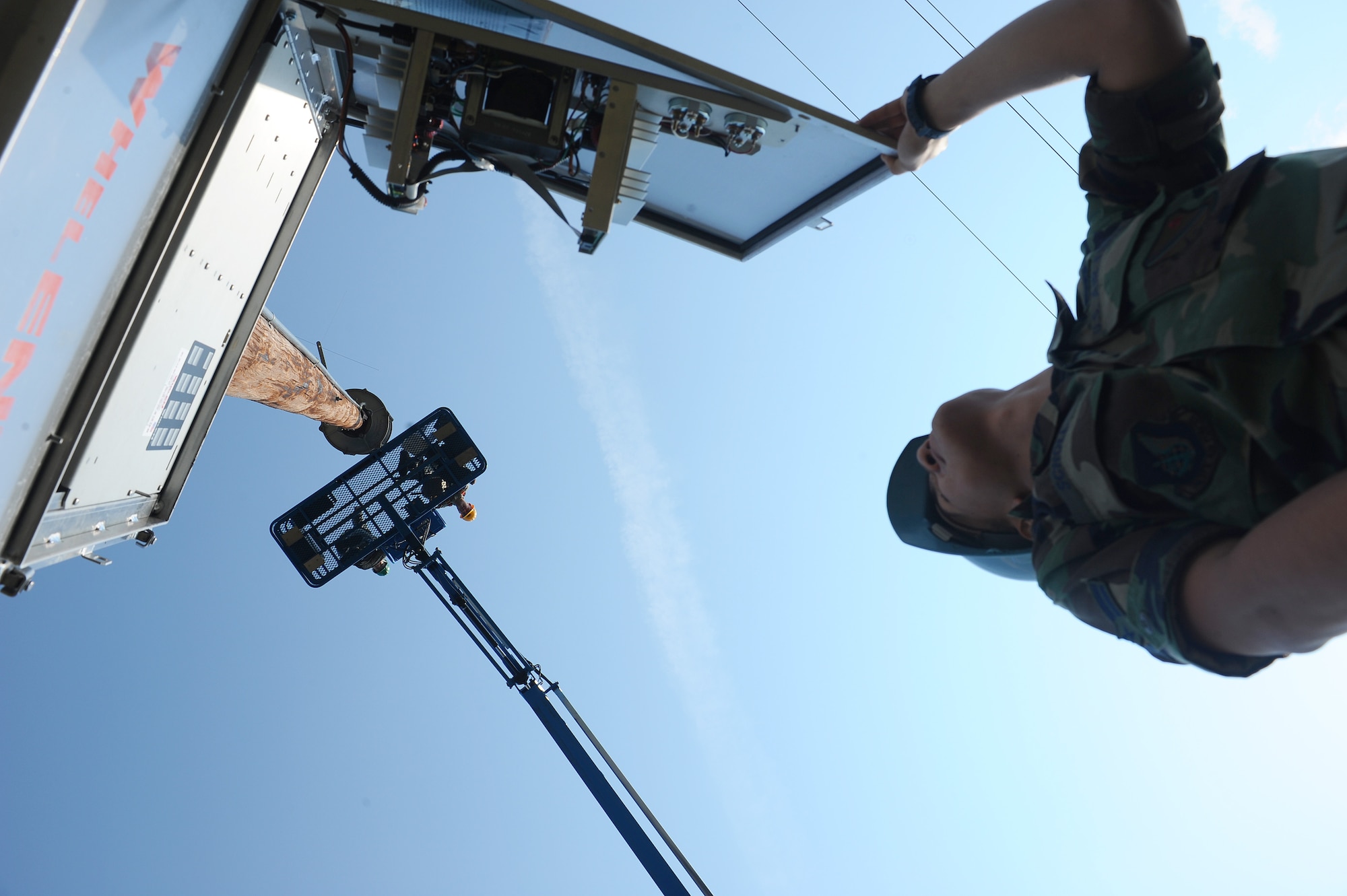 Senior Airman Lance Egan communicates from an aerial platform 55 feet high to Airman 1st Class Jonathan Scholl on the ground while he is controlling the giant voice system locally for a sound test Aug. 13, 2008, at Eielson Air Force Base, Alaska. The radio maintenance shop conducts preventive maintenance inspections on every giant voice system to ensure it works properly when needed to inform base populace. Both Airmen are assigned to the 354th Communication Squadron.  (U.S. Air Force photo by Airman 1st Class Jonathan Snyder)