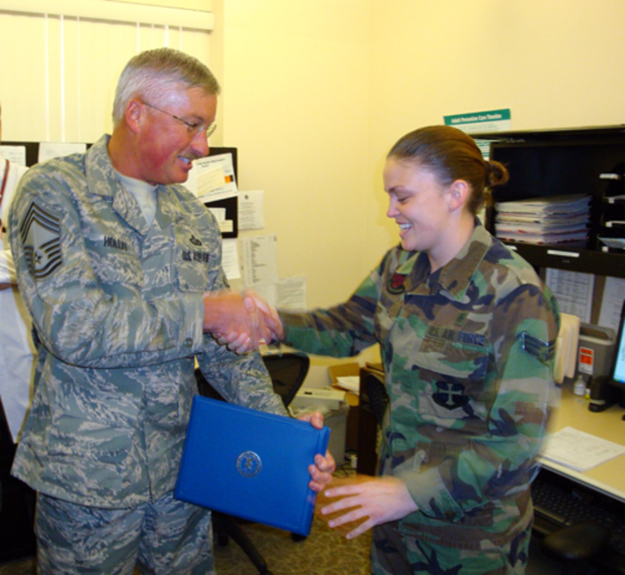 Senior Airman Jennifer Maloy (right),  95th Medical Operations Squadron medical technician, received the Dare to Soar Award Aug. 14 from Chief Master Sgt. Andrew Hollis (left), 95th Mission Support Squadron superintendent. Airman Maloy received the award by garnering the most positive feedback in her duty section. In addition to the Dare to Soar award, she also received the 95th Air Base Wing Airman of the Quarter Award in the 3rd quarter. The Dare to Soar Award is presented by the Chiefs Group to Airmen who go above and beyond in the performance of their duties. (Air Force photo by Chief Master Sgt. Luis Drummond)