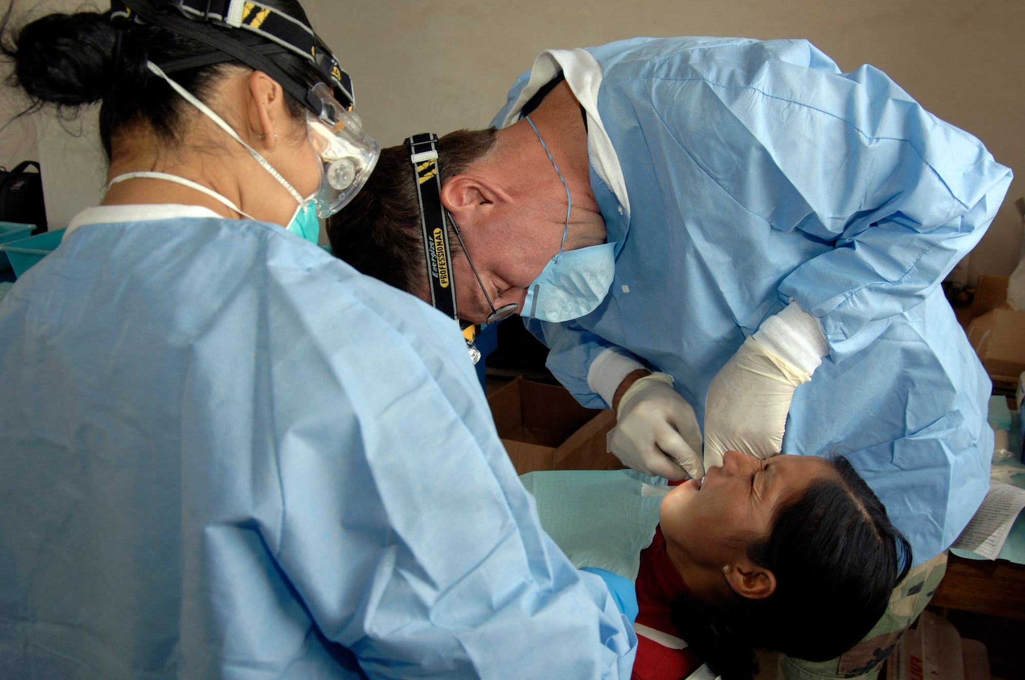 Dr. (Lt. Col.) Walter Weaver and Senior Airman Betty Goldsmith, a dental technician, extract a tooth from a Peruvian woman during a medical mission in Mollepata, Peru, Aug. 1.  A team of 19 medical professionals from the 433rd Medical Group at Lackland Air Force Base, Texas, are deployed to Ayacucho, Peru, to support New Horizons - Peru 2008, a humanitarian mission set on bringing quality-of-life construction projects and a total of nine medical missions to underpriviliged Peruvians. (U.S. Air Force photo/1st Lt. Mary Pekas)