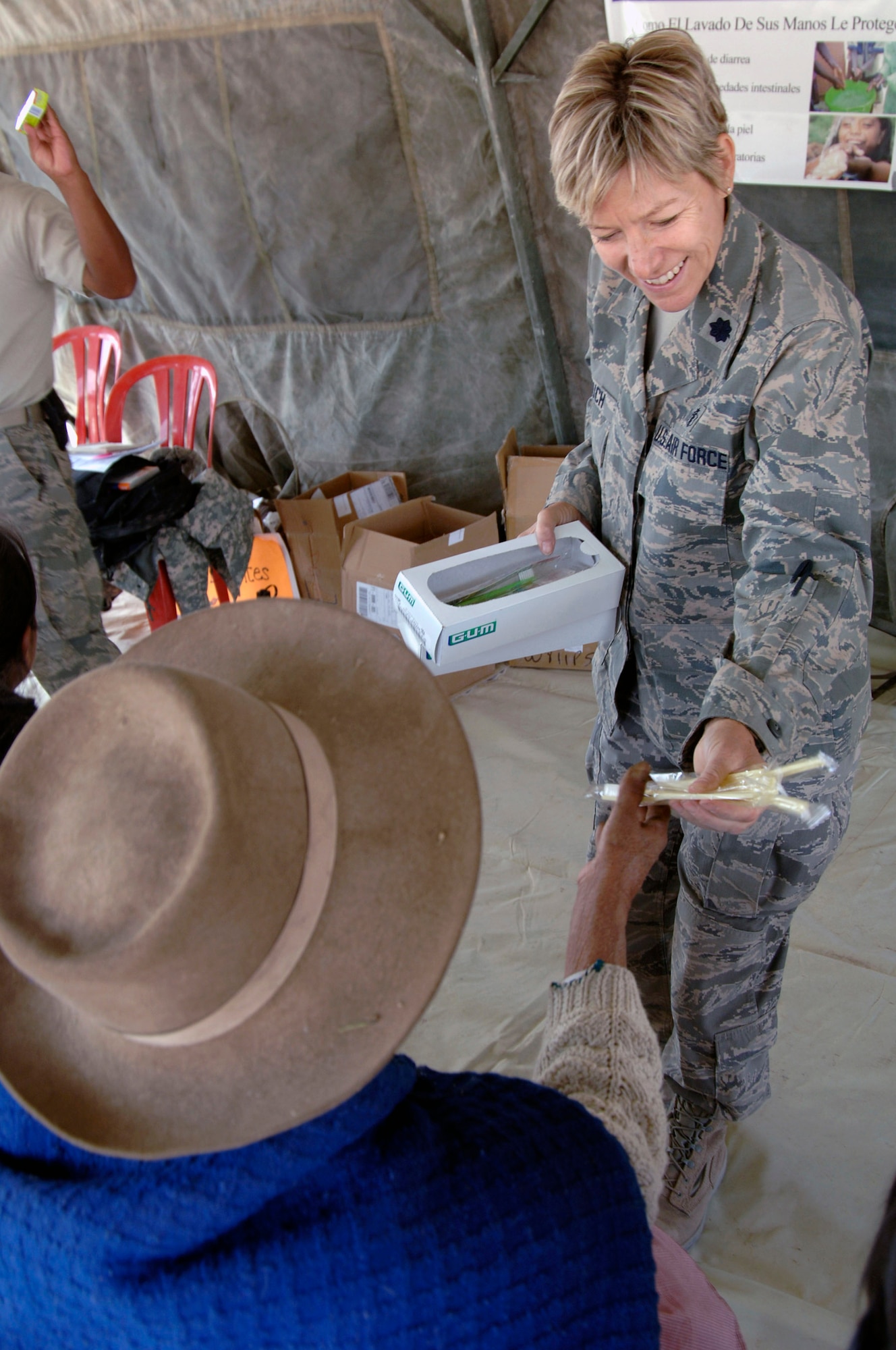 Lt. Col. Helen Crouch passes out toothbrushes to Peruvian people listening to a public health lecture during a medical mission in Mollepata, Peru, Aug. 1. A team of 19 medical personnel deployed to Ayacucho, Peru, to support the final three of nine medical missions supporting New Horizons - Peru 2008. The mission is a U.S. and Peruvian effort to bring humanitarian aid to underpriviliged Peruvians. Colonel Crouch is from the 433rd Medical Group at Lackland Air Force Base, Texas. (U.S. Air Force photo/1st Lt. Mary Pekas)