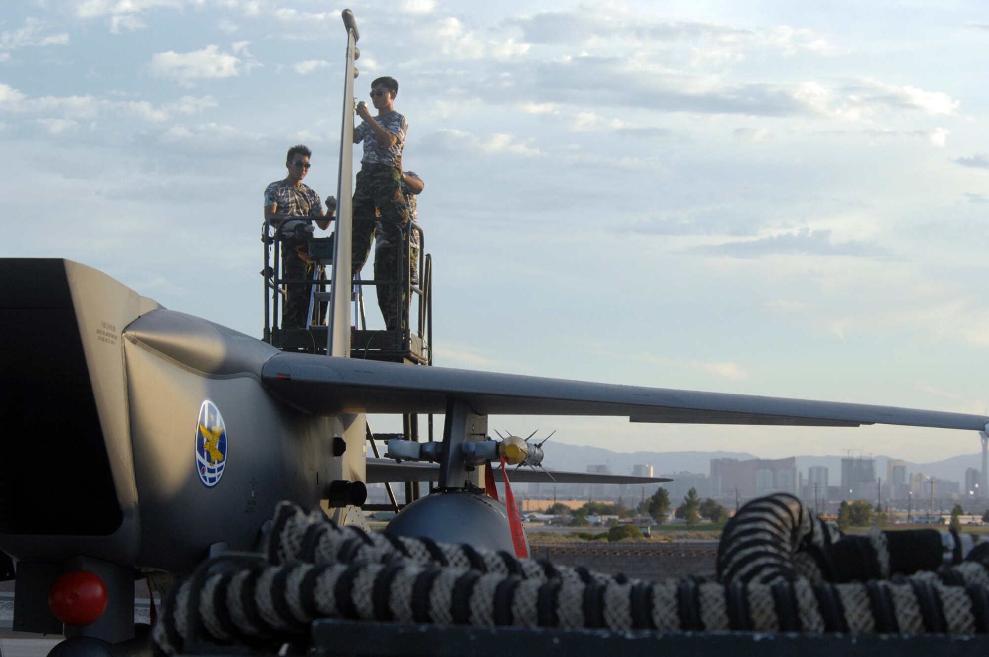 Aircraft Maintainers with the Republic of Korea Air Force conducts post-flight maintenance on a F-15K Slam Eagle following a Red Flag mission at Nellis Air Force Base, Nev., Aug. 13, 2008. ROKAF aircraft and crews are participating in their first Red Flag exercise. Red Flag provides a peacetime "battlefield" within which U.S. and allied aircrews train to fight, survive and win. (U.S. Air Force photo by: Airman 1st Class Ryan Whitney) 
