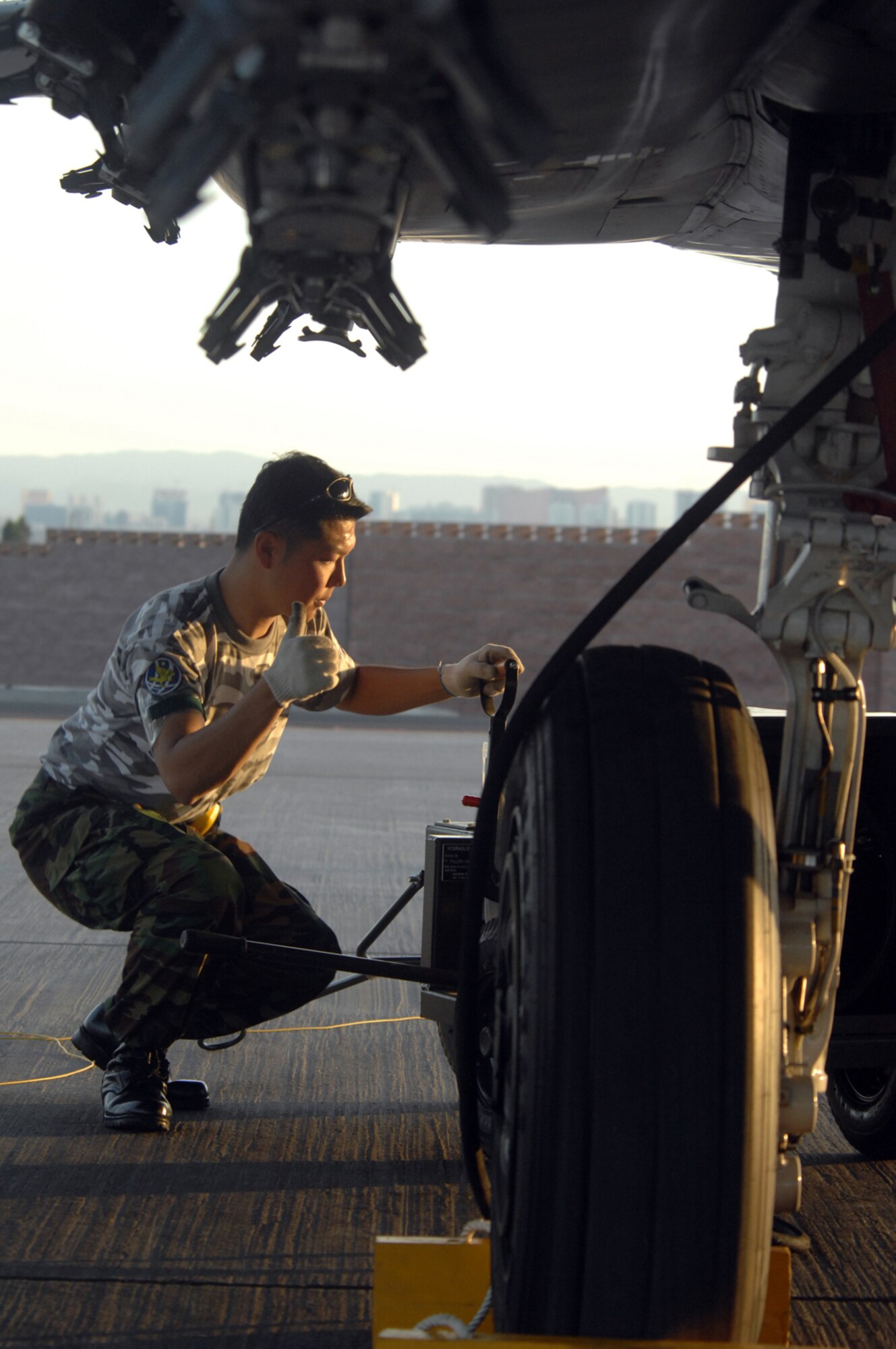 A member of the Republic of Korea Air Force conducts post-flight maintenance on a F-15K Slam Eagle following a Red Flag mission at Nellis Air Force Base, Nev., Aug. 13, 2008. ROKAF aircraft and crews are participating in their first Red Flag exercise. Red Flag provides a peacetime "battlefield" within which U.S. and allied aircrews train to fight, survive and win. (U.S. Air Force photo by: Airman 1st Class Ryan Whitney) 
