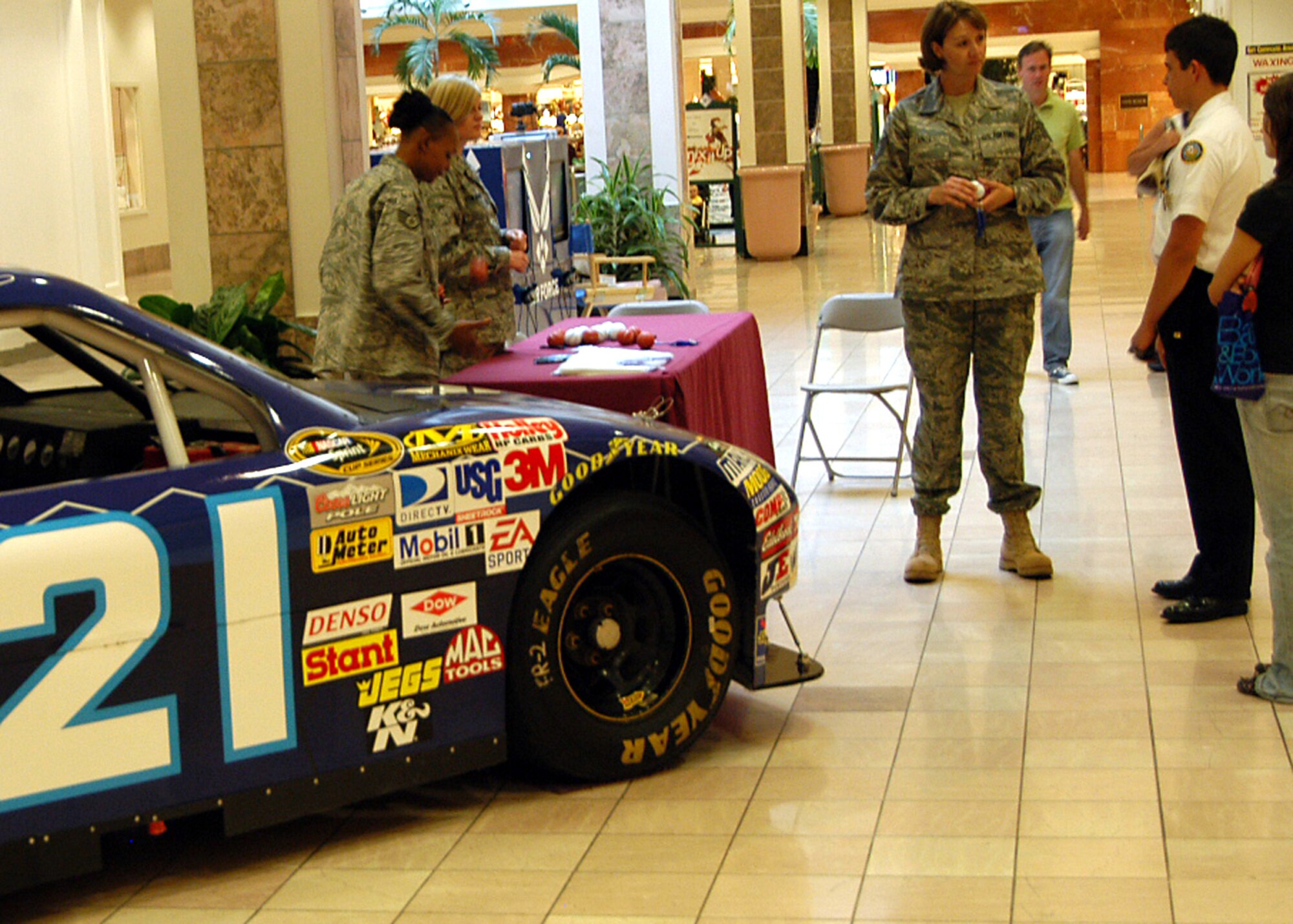 Tech. Sgt. Tammy Hall, 343rd Recruiting Squadron, speaks with patrons of the West Roads Mall in Omaha, Neb., Aug. 10. The NASCAR display was one of many “Air Force Week in the Heartland” events taking place through the week, designed to educate and inform the public about the Air Force. (U.S. Air Force photo/Tech. Sgt. David McCarrison)