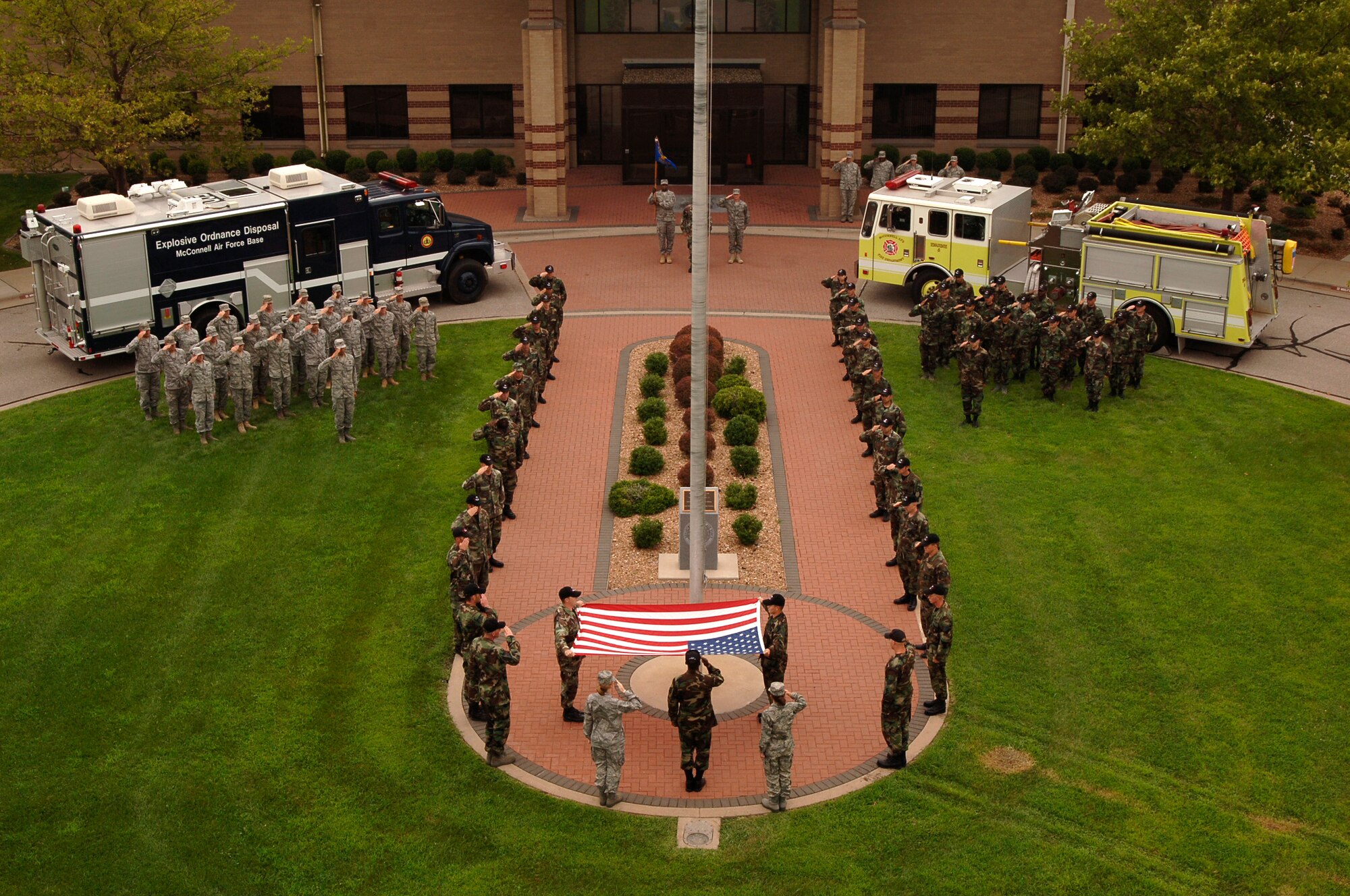 MCCONNELL AIR FORCE BASE, Kan.  -- 22nd Civil Engineering Squadron Airmen hold the American Flag unfurled during a retreat ceremony, Aug. 7. Volunteers from the squadron came out to stand in formation to honor the flag during the ceremony. (Photo by Airman Justin Shelton)