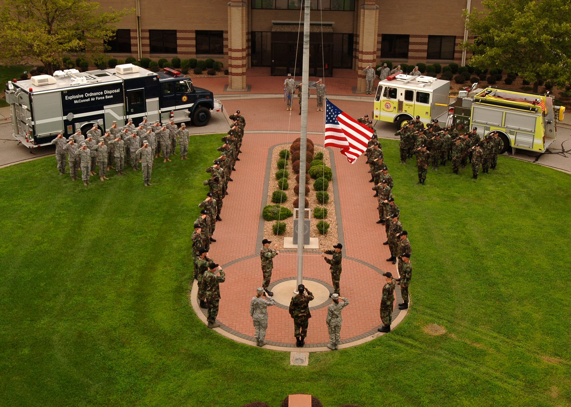 MCCONNELL AIR FORCE BASE, Kan. -- 22nd Civil Engineering Squadron Airmen lower the American Flag for folding during a retreat ceremony, Aug. 7. The squadron rendered a salute to the flag until the folding began and then stood at attention within their respective flights until the ceremony had ended. (Photo by Airman Justin Shelton)