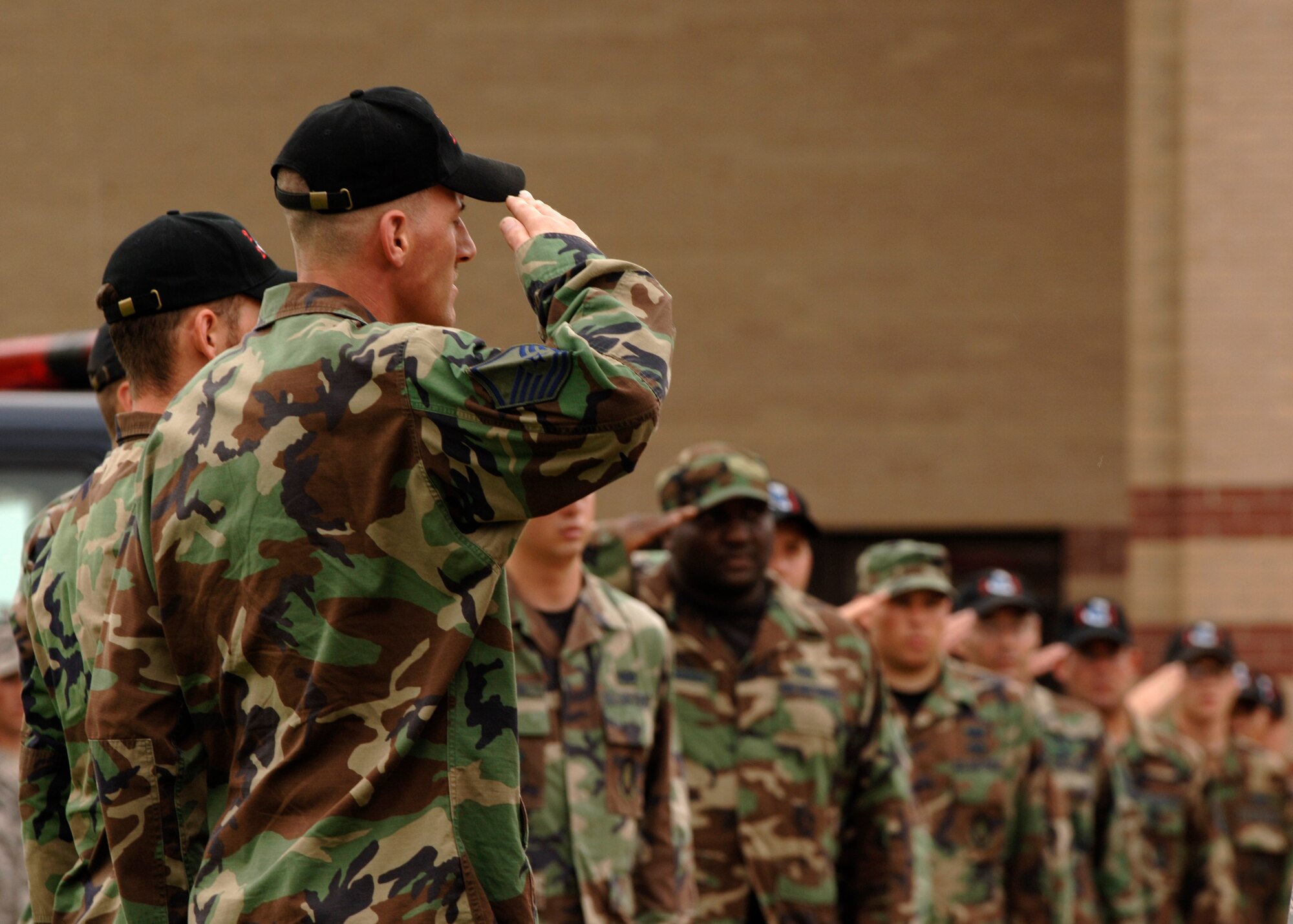 MCCONNELL AIR FORCE BASE, Kan.  -- 22nd Civil Engineer personnel salute the American Flag during a retreat ceremony, Aug. 7. A retreat ceremony not only signifies the end of the duty day, but it is also a means of paying respects to the flag and those individuals who have come before. (Photo by Staff Sgt. Jamie Train)