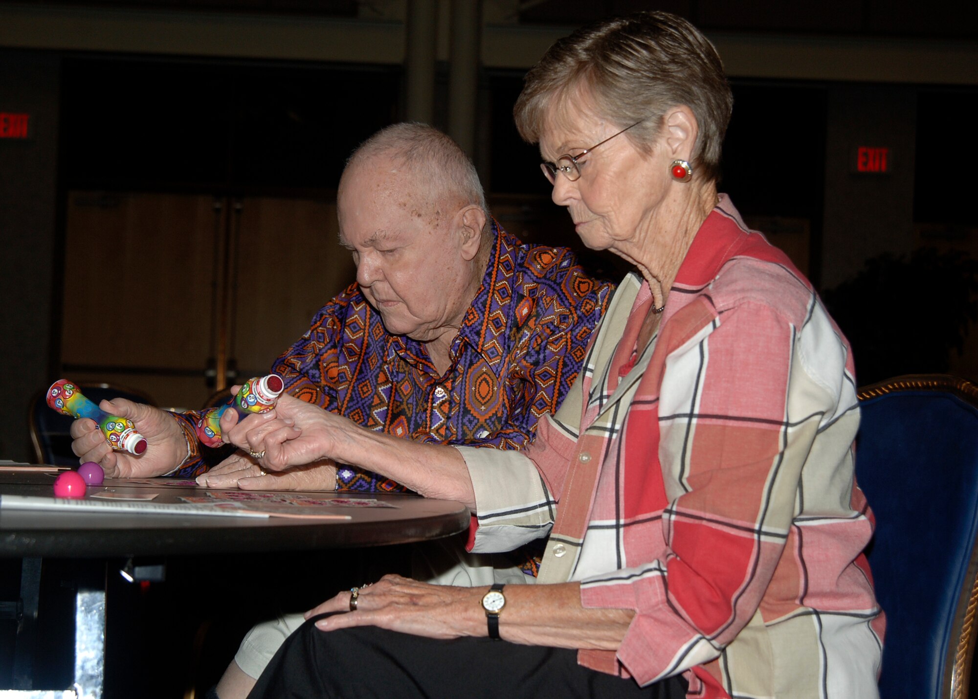 MCCONNELL AIR FORCE BASE, Kan. -- Faye Ripper and her husband Bill Ripper play a second round of bingo after winning a luggage bag containing an Air Force mug and notepad during the 22nd Force Support Squadron’s Retiree Bingo event at the Robert J. Dole Community Center, Aug. 12. All retired military members are invited to a monthly luncheon where they receive updates on the base community and have the opportunity to play bingo for prizes. For more information, call the community center at 759-6023. (Photo by Airman Justin Shelton)