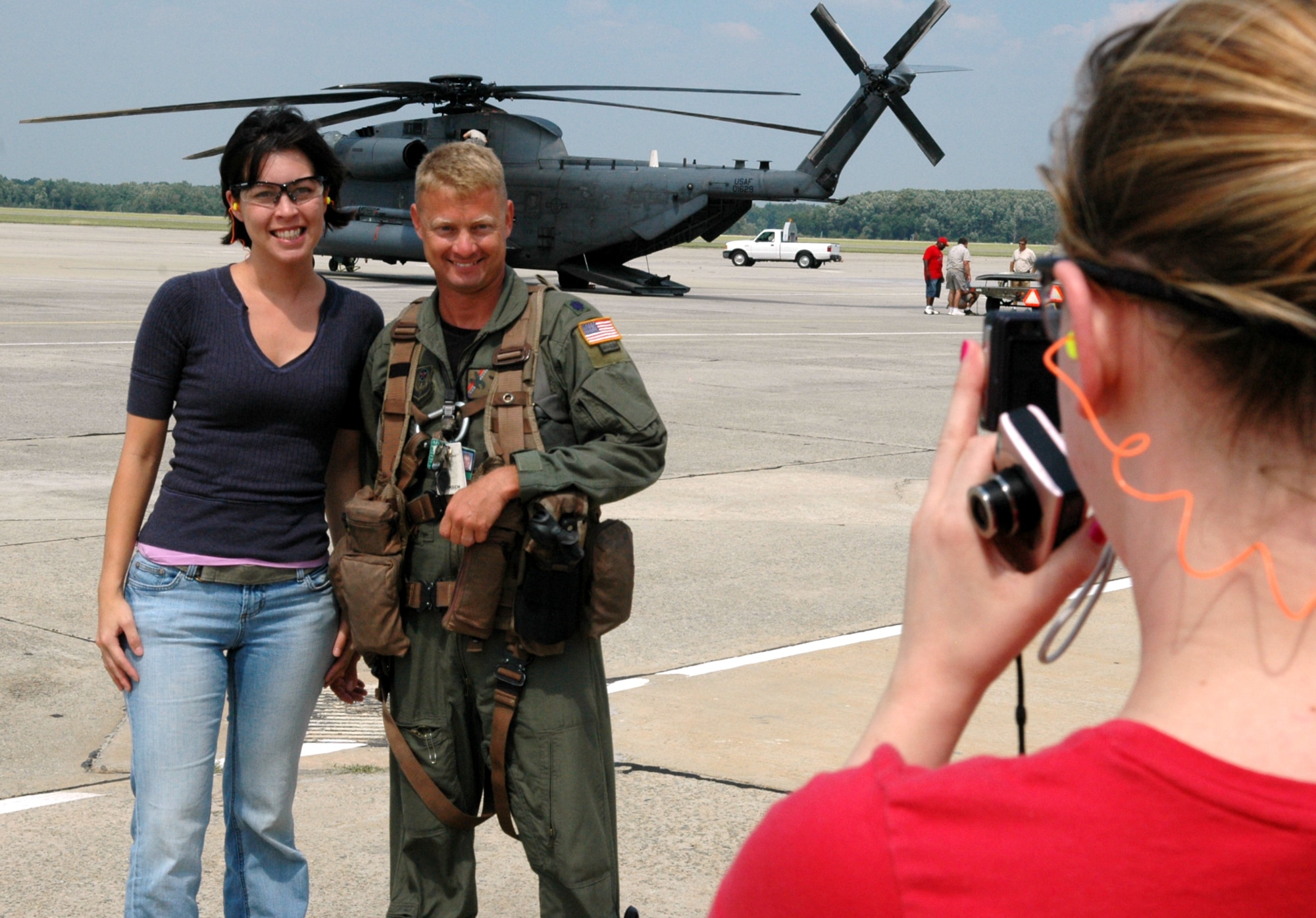 Jackline Baker, 411th Supply Chain Management Squadron, has her photo taken with Lt. Col. Sean Hoyer who was with the crew that brought the MH-53 to Robins. U. S. Air Force photo by Sue Sapp