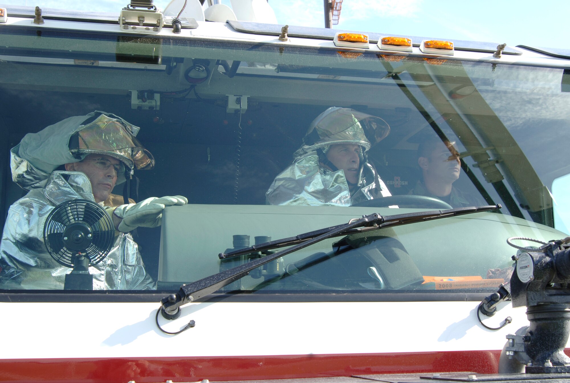 MCCONNELL AIR FORCE BASE, Kan. -- Col. Michael Krueger, 22nd Air Refueling Wing vice commander, controls a Crash four Striker while Col. Mark White, 22nd Mission Support Group commander and Staff Sgt. Stephen Harwell, 22nd Civil Engineer Squadron, watch on the flight line Aug. 8. Colonel Krueger and Colonel White met with Airmen and where able to tour the 22nd Civil Engineer Squadron, Fire and Emergency Services Flight’s capabilities first hand. (Photo by Senior Airman Roy Lynch III)