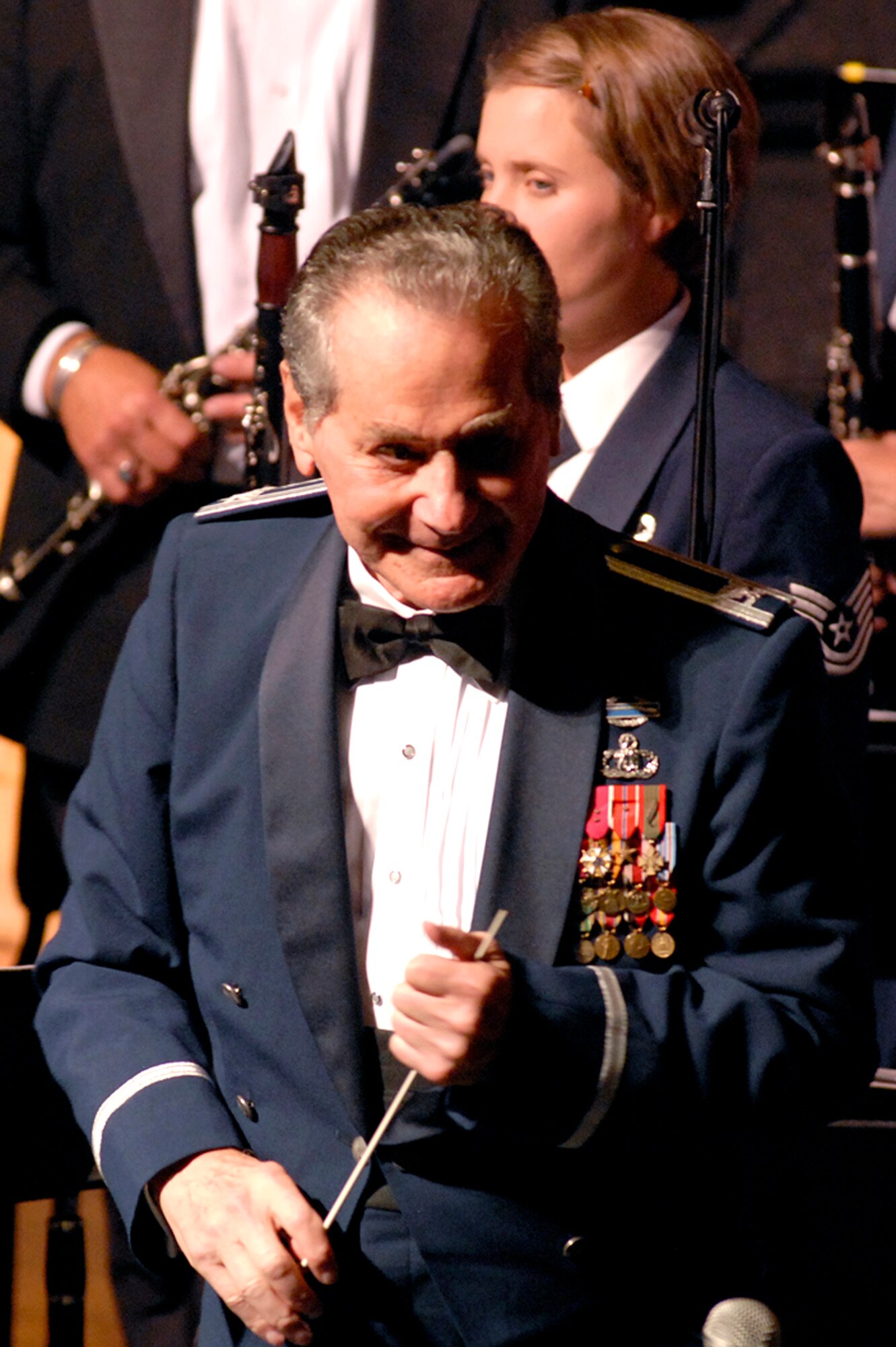 Col. (ret.) Arnald Gabriel, U.S. Air Force band conductor, and members of the U.S. Air Force Academy Band stand before a packed house Aug. 8 at the Pikes Peak Center in Colorado Springs, Colo. The USAFA Band hosted the 2008 Air Force Musicians Association Conference and Reunion Aug. 7-8, sponsoring several events and performances, including vocal, wind and percussion clinics and a "Summertime Favorites" show for attendees. (U.S. Air Force photo/Craig Denton)