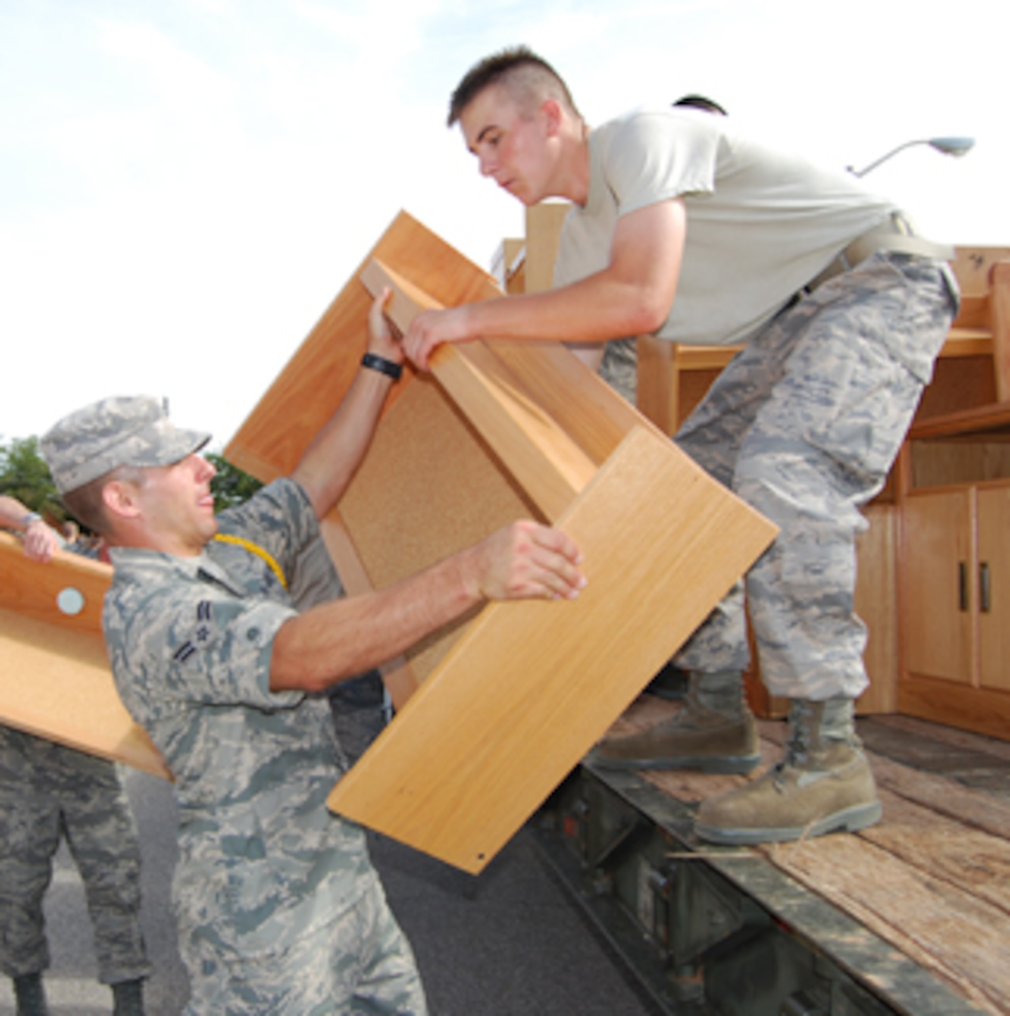 Airman 1st Class Ryan Leuer and Airman Ryan McCullough, students from the 366th Training Squadron, load a truck with furniture to be transported to the Receive In Place Location. About 1,200 Airmen in Training from every squadron moved over 1,000 pieces of furniture out of a dormitory to RIPL, a central location for Sheppard members to go if they want to reuse the furniture. (U.S. Air Force photo/Airman 1st Class Candy Miller) 