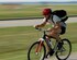 Tech. Sgt. Levi Collins, 1st Fighter Wing Public Affairs photographic craftsman, enjoys his daily commute to work on his bicycle here on Aug. 6.  (U.S. Air Force photo/Airman 1st Class Zachary Wolf)