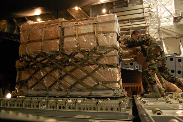 Crewmembers unload a pallet of humanitarian supplies from a C-17 Globemaster III in Tbilisi, Georgia.  The pallet contains cots, blankets and medical supplies.  Sixteen pallets of humanitarian supplies were delivered in the wake of conflict over the past week. (Department of Defense photo /Navy Lt. Cmdr Corey Barker)