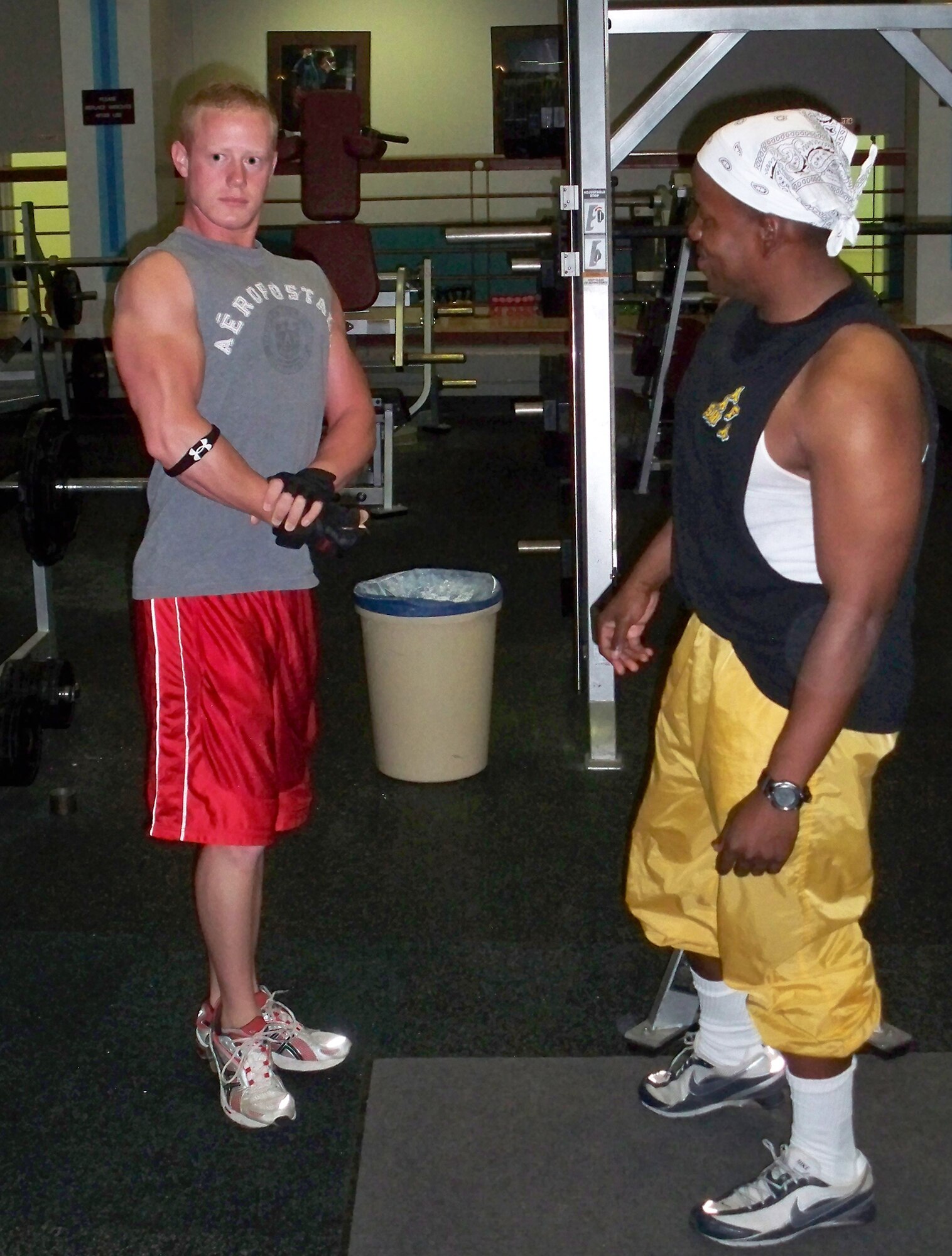 WHITEMAN AIR FORCE BASE, Mo. – Capt. Michael Boswell, 509th Logistics Readiness Squadron and WAFB bodybuilding coach, instructs Airman 1st Class Stephen Linch, 509th Bomb Wing Public Affairs, how to hold a pose that he will have to perform at the Sept. 27 North American National Bodybuilding Federation bodybuilding competition. Airman Linch is one of 12 WAFB Body Building Team members training for upcoming competitions.  (U.S. Air Force photo/Stephanie Fowler)