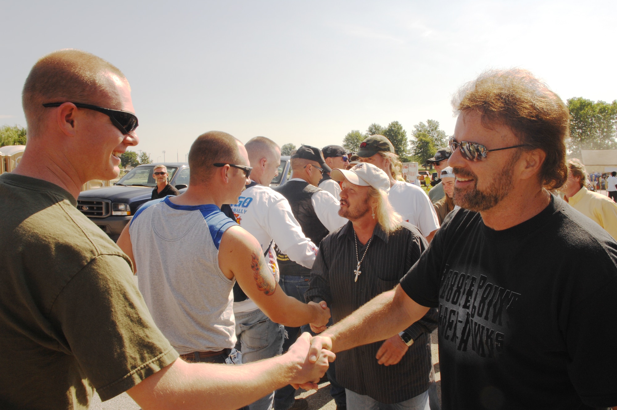 WHITEMAN AIR FORCE BASE, Mo. - Members of rock band .38 Special meet and greet military members, families and civiilian workers Aug. 8 during the Atomic Luau hled at Whiteman Air Force Base, Mo. 
