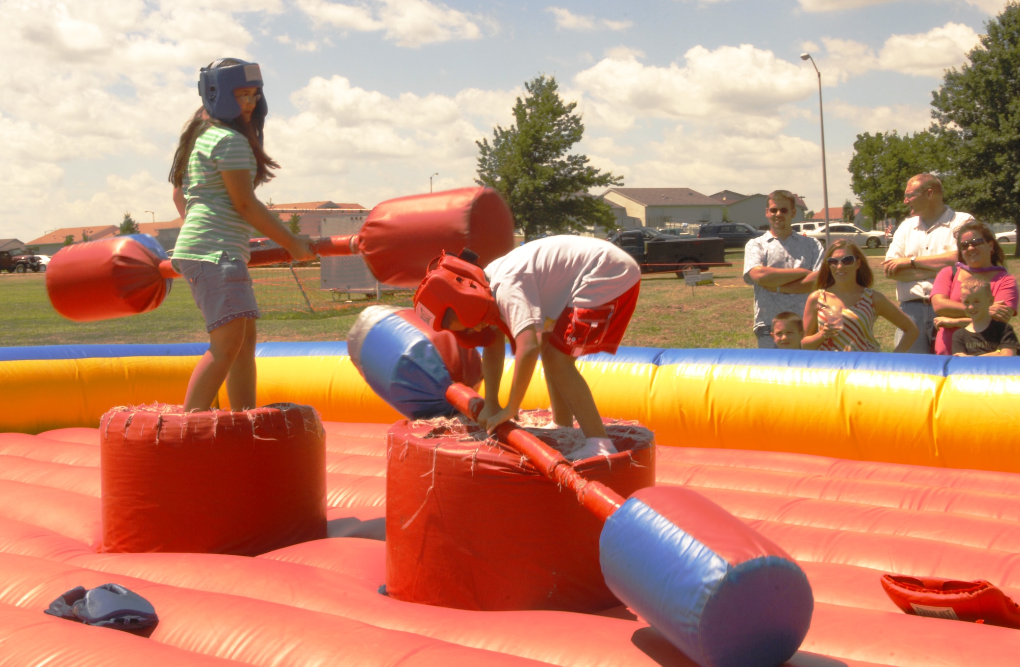 WHITEMAN AIR FORCE BASE, Mo. - Two children joust Aug. 8 during the Whiteman Air Force Base Atomic Luau. whiteman hosts an annual luau open to military members, families and civilians who work on base. The Atomic Luau provided food, music and attractions for others to take part in. (U.S. Air Force photo/Senior Airman Jessica Snow)