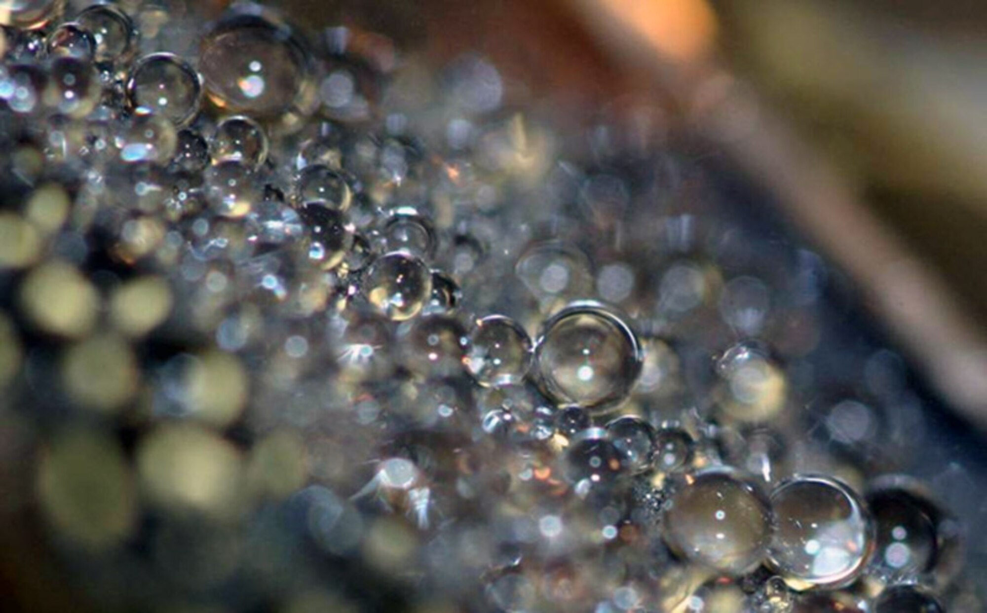 This image shows how a transparent coating causes water to bead up into drops and roll or bounce off a surface. This new technology will help protect and sustain Air Force systems by preventing corrosion and reducing ice formation on optical elements and aircraft. (Courtesy photo) 
