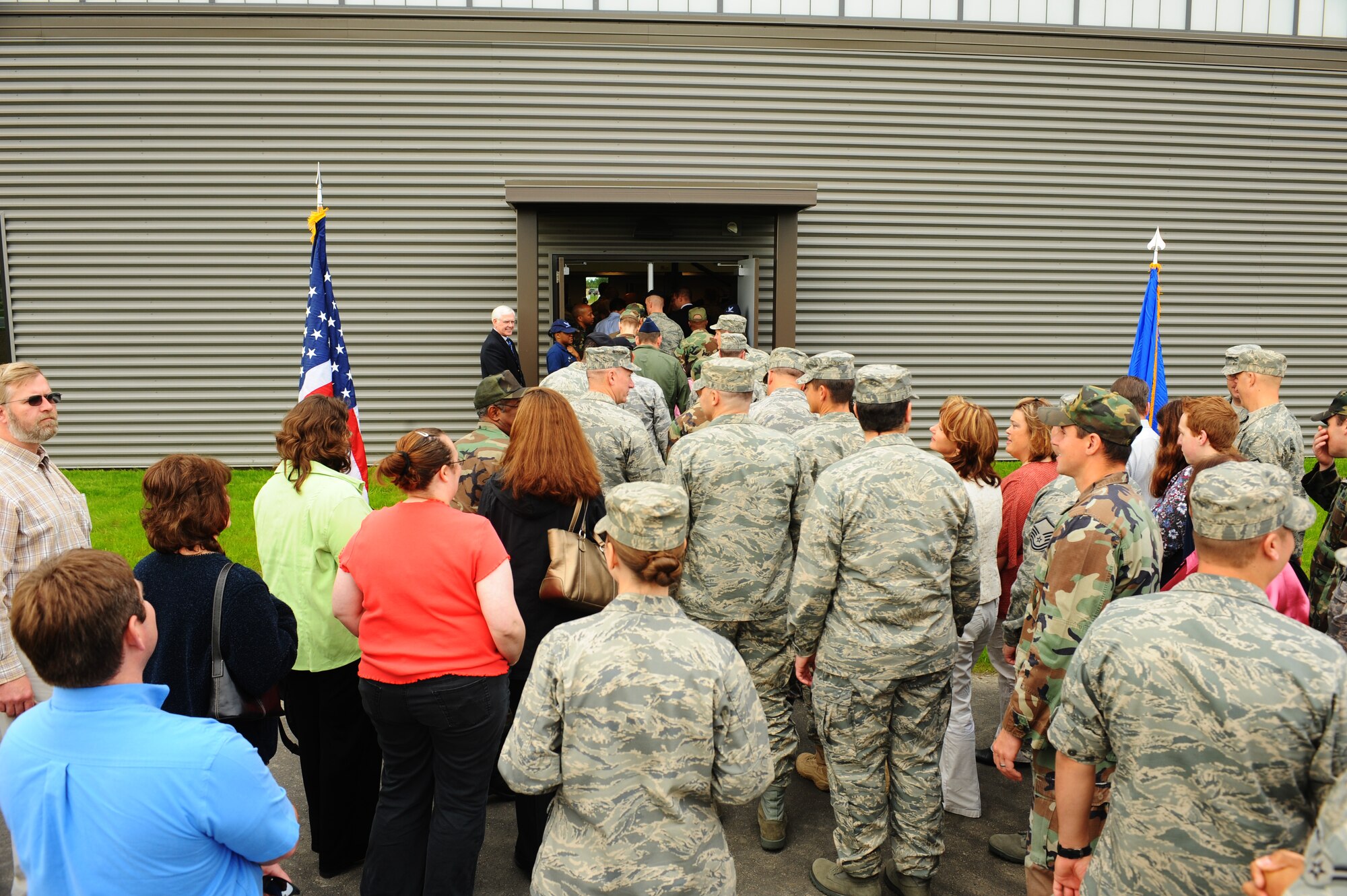 Airmen and civilians make their way into the new fitness center addition during the official grand opening ceremony Aug. 13, 2008, at Eielson Air Force Base, Alaska. The new addition has an indoor track and field, lifting equipment rooms along with Health and Wellness Center classrooms. (U.S. Air Force photo by Airman 1st Class Jonathan Snyder)