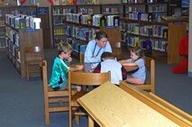 MINOT AIR FORCE BASE, N.D. -- Children and adults alike brush up on reading skills at the base library in the Francis X. Deignan Center here Aug. 6 for the quality of life area of the three-fold mission supported by the library. The three areas maintained are: mission, education and quality of life. (U.S. Air Force photo by Airman 1st Class Benjamin Stratton)