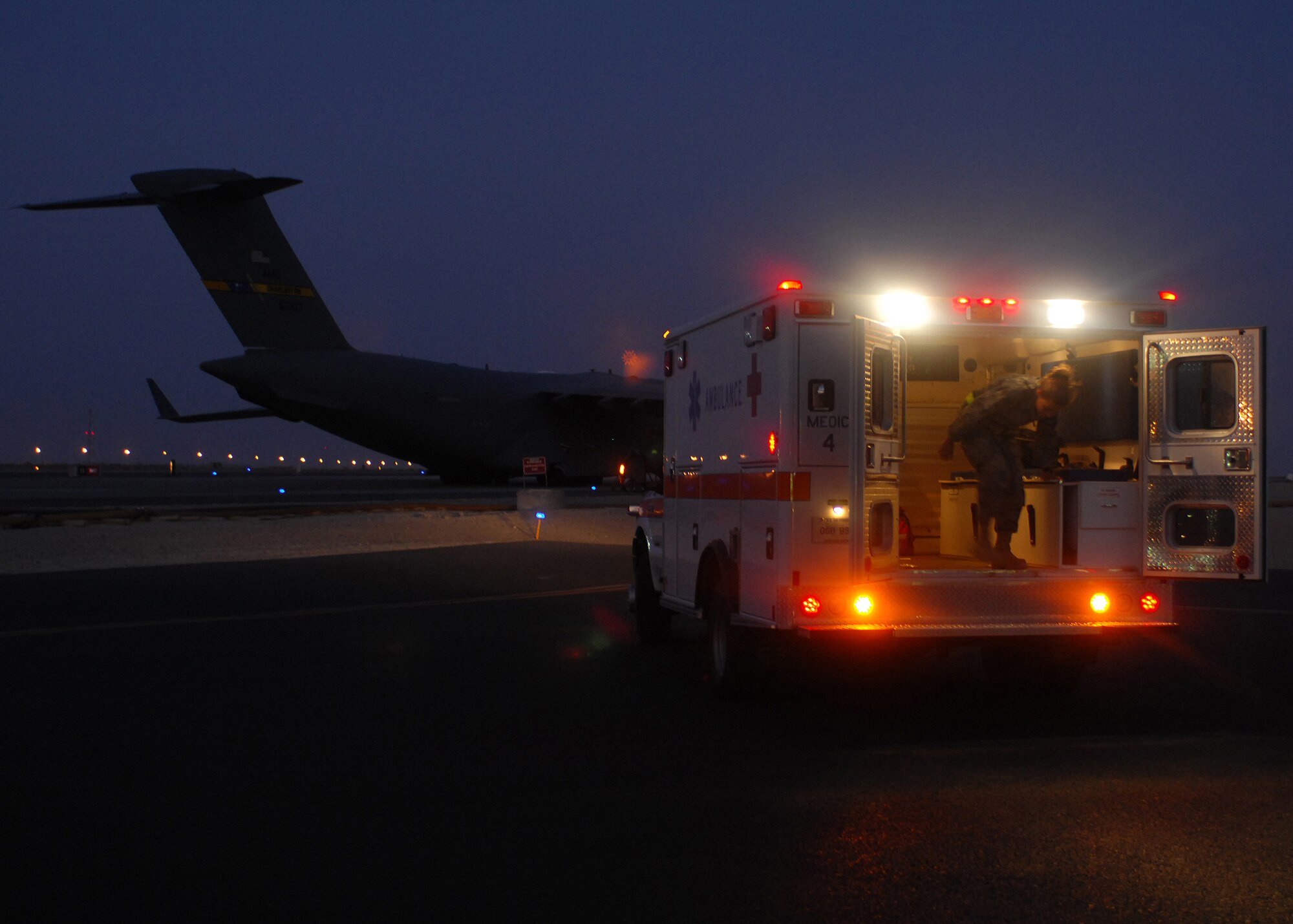 SOUTHWEST ASIA -- In the early hours of the morning, Senior Airman Nicole Palko, 386th Expeditionary Medical Group, readies an ambulance to transport an injured Soldier to the Contingency Aeromedical Staging Facility at an air base in Southwest Asia. The CASF is a medical facility that provides personnel and equipment for the aeromedical evacuation of ill and wounded U.S. and coalition force members. Patients from forward positions in the U.S. Central Command area of responsibility are transported from the CASF to medical centers in Europe and the continental U.S. Airman Palko is deployed from Wright-Patterson Air Force Base, Ohio. (U.S. Air Force photo/Tech. Sgt. Raheem Moore)