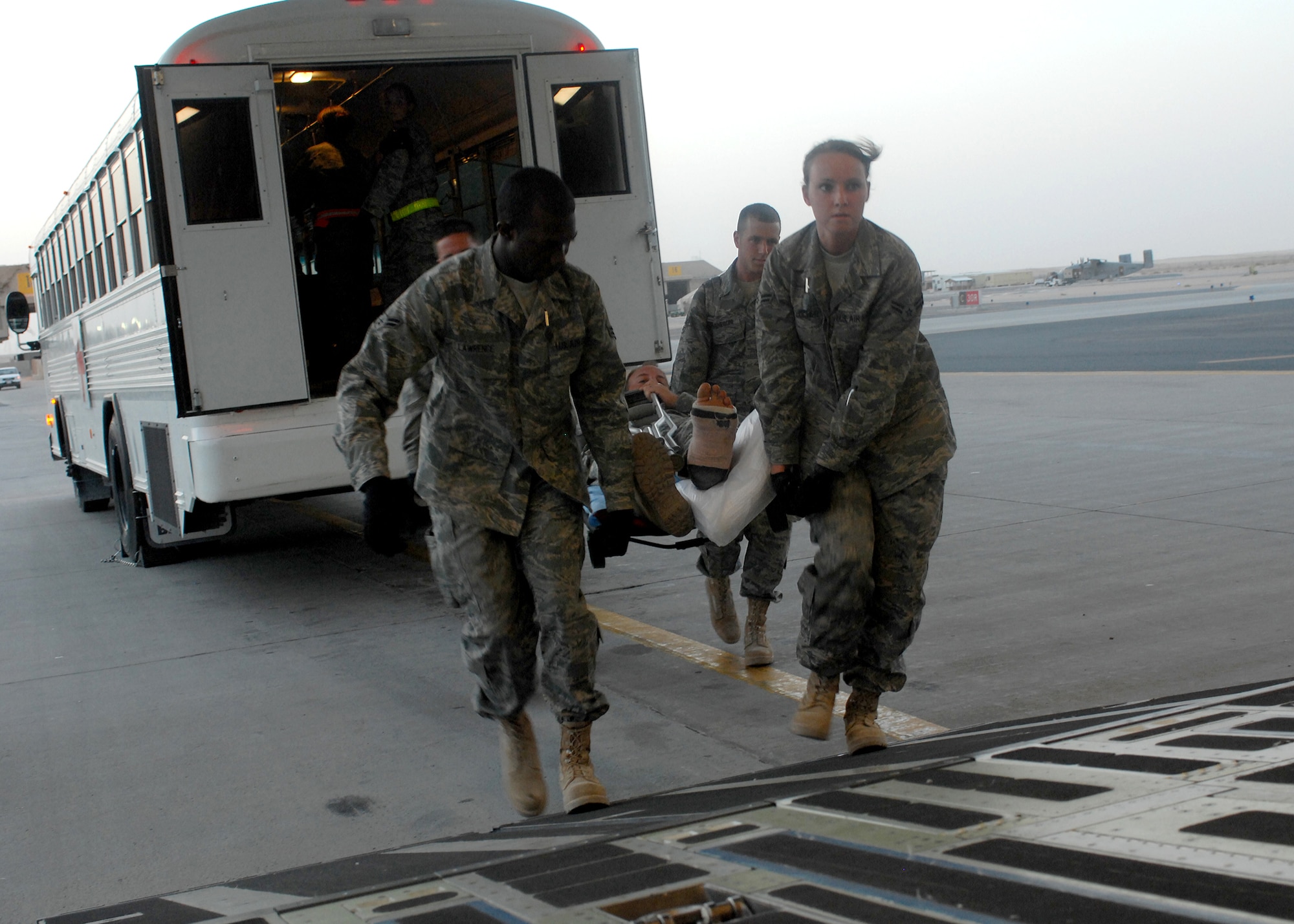 SOUTHWEST ASIA -- Members of the Contingency Aeromedical Staging Facility at an air base in Southwest Asia transport an injured patient onboard a C-17 for medevac to Landstuhl Regional Medical Center in Germany. The CASF is a medical facility that provides personnel and equipment for the aeromedical evacuation of ill and wounded U.S. and coalition force members. Patients from forward positions in the U.S. Central Command area of responsibility are transported from the CASF to medical centers in Europe and the continental U.S. (U.S. Air Force photo/Tech. Sgt. Raheem Moore)