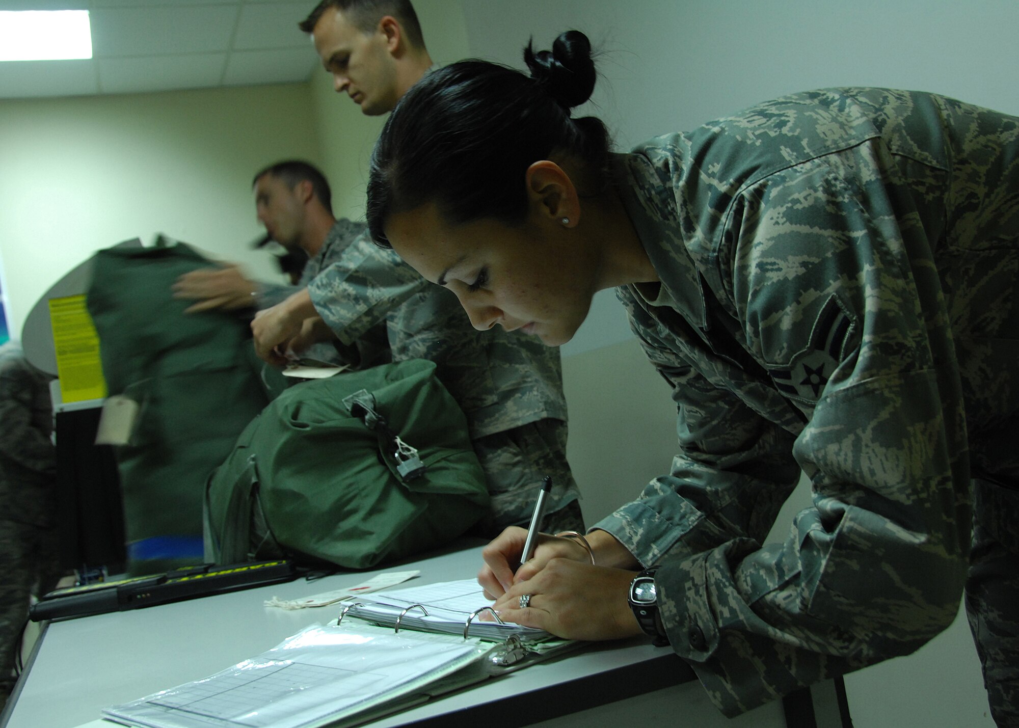 SOUTHWEST ASIA -- Airman 1st Class Johana Montoya, 386th Expeditionary Medical Group, writes down a bag identification number after scanning luggage through a metal detector at the Contingency Aeromedical Staging Facility at a base in Southwest Asia. Medical technicians perform anti-hijacking procedures while admitting and discharging patients and their luggage, to ensure a safe flight to other medical centers in Europe and the continental U.S. The CASF is a medical facility that provides personnel and equipment for the aeromedical evacuation of ill and wounded U.S. and coalition force members. Airman Montoya is deployed from Wright-Patterson Air Force Base, Ohio. (U.S. Air Force photo/Tech. Sgt. Raheem Moore)