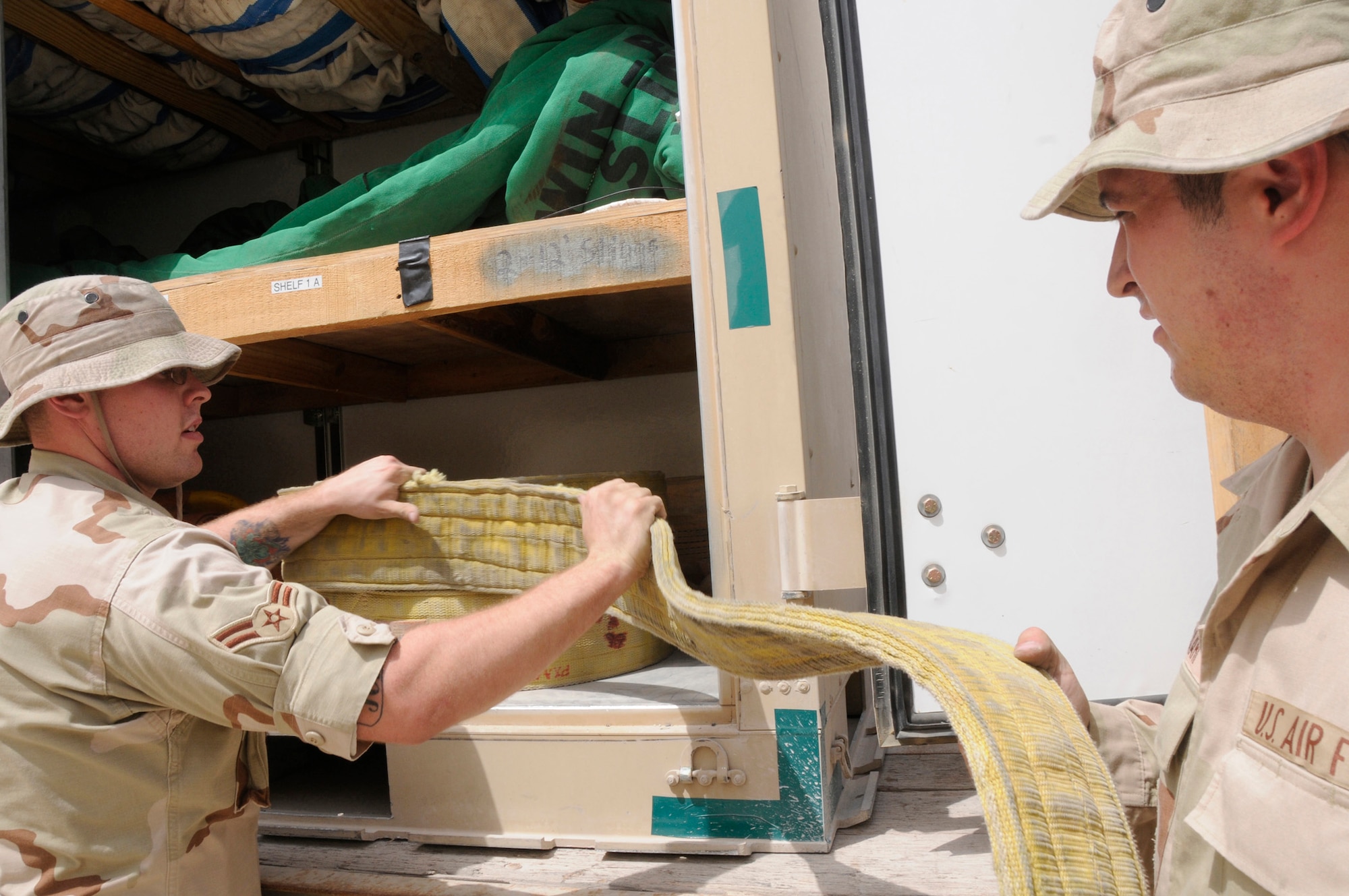 Airman 1st Class Daniel Breen and Airman 1st Class Garry Saari, repair and reclamation journeyman with the 379th Expeditionary Maintenance Squadron, inspect slings stored in their crash trailer Aug. 14, 2008, at an undisclosed air base in Southwest Asia. The 379th Expeditionary Maintenance Squadron is responsible for recovering aircraft and clearing the debris of crashed aircraft throughout the U.S. Central Command’s area of responsibility. Airman Breen, a native of Alliance, Neb., is deployed from Grand forks Air Force Base, N.D., and Airman Saari, a native of Las Vegas, Nev., is deployed from Ellsworth Air Force Base, S.D., in support of Operations Iraqi Freedom, Enduring Freedom and Joint Task Force-Horn of Africa. (U.S. Air Force photo by Staff Sgt. Darnell T. Cannady)