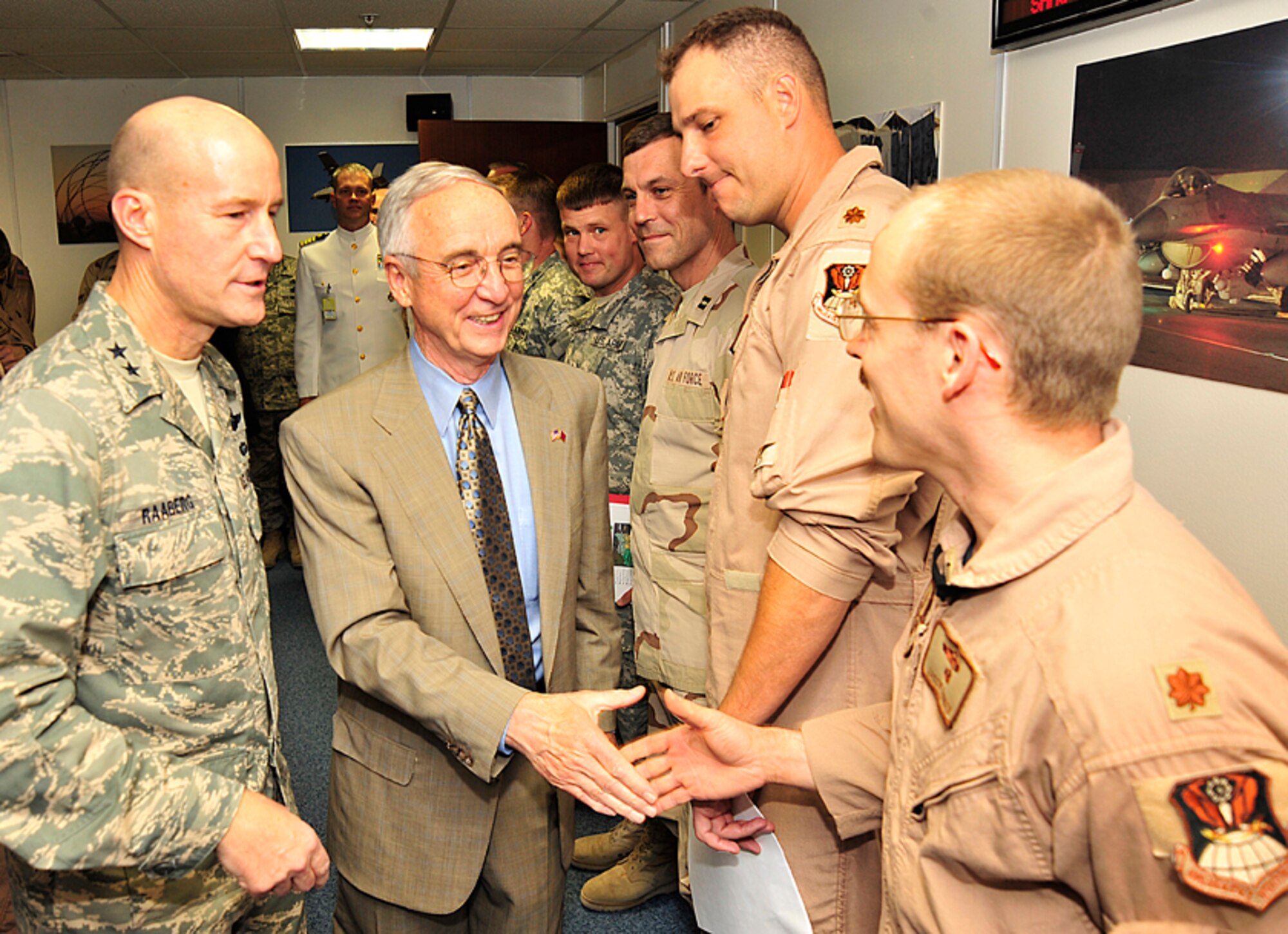 SOUTHWEST ASIA --  Deputy Secretary of Defense Gordon England greets servicemembers at the Combined Air and Space Operation Center here, accompanied by Air Force Maj. Gen. Douglas Raaberg, deputy combined force air component commander. In conjunction with his visit to the U.S. Central Command area of responsibility, Secretary England visited with coalition members at the CAOC and received a briefing on current air operations throughout the theater.  (U.S. Air Force photo by SSgt. Aaron Allmon).
