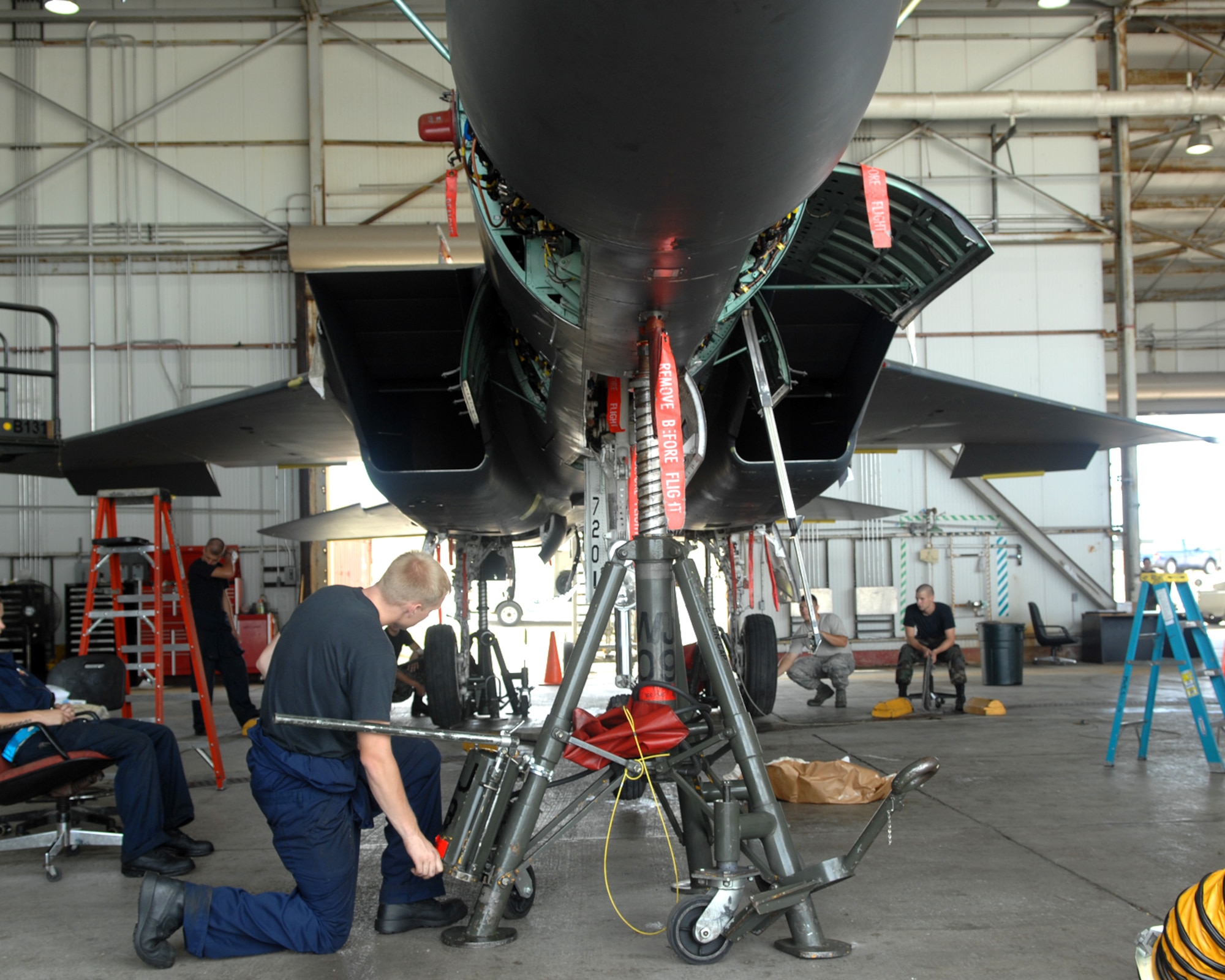 ANDERSEN AIR FORCE BASE, Guam - Members of the 389th Expeditionary Aircraft Maintenance Squadron, lower an F-15E Strike Eagle during its phase maintenance Aug. 14. A phase inspection is a group of maintenance squadron flights working together towards a common goal, which is the completion of the inspection, a phase inspection is a miniature overhaul for the aircraft that is performed every 400 flight hours. (U.S. Air Force photo by Airman 1st Class Cory Todd)